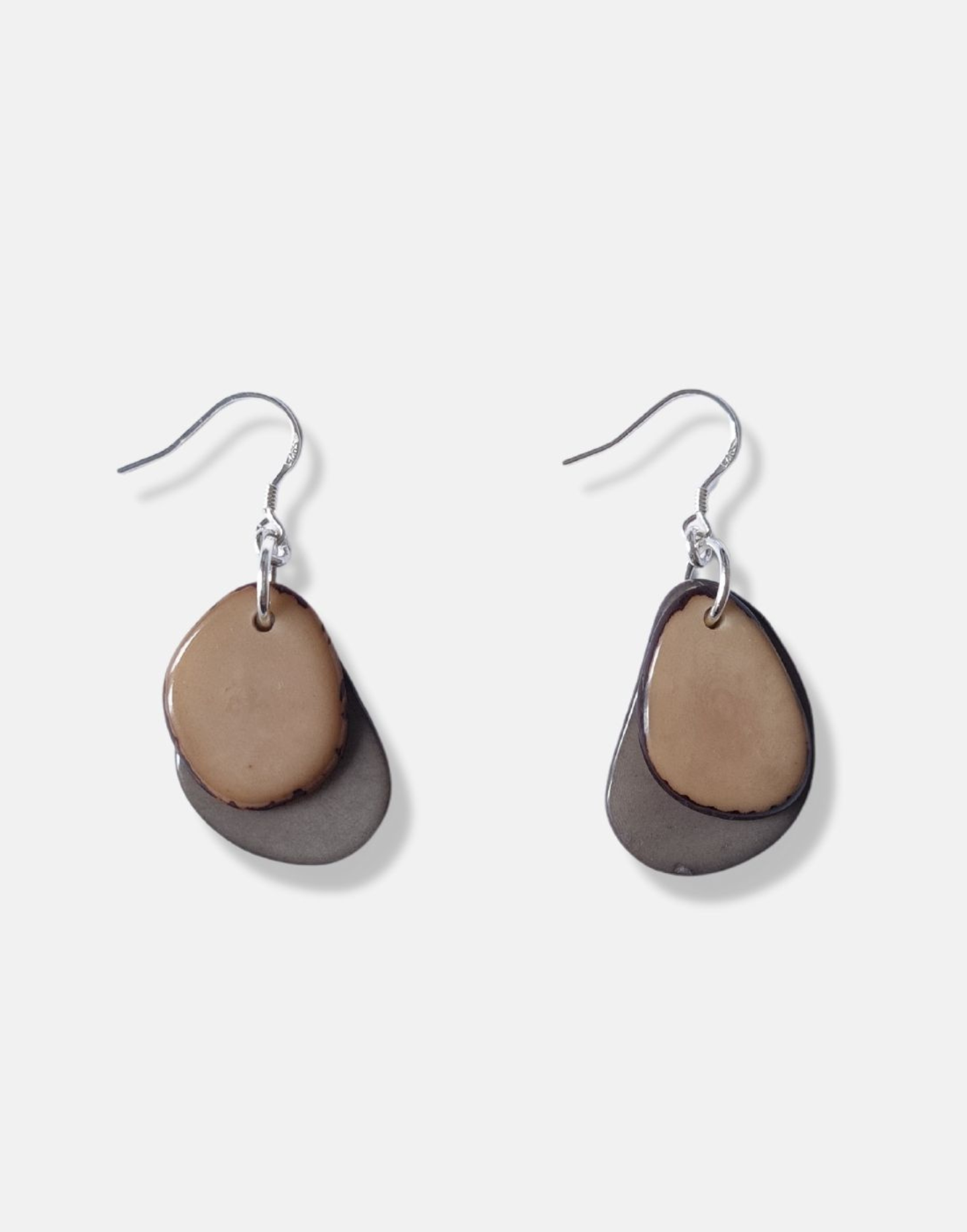 A pair of Secca Tagua Nut Earrings featuring organic vegetable ivory slices and sterling silver hooks, elegantly displayed in eco-friendly packaging.