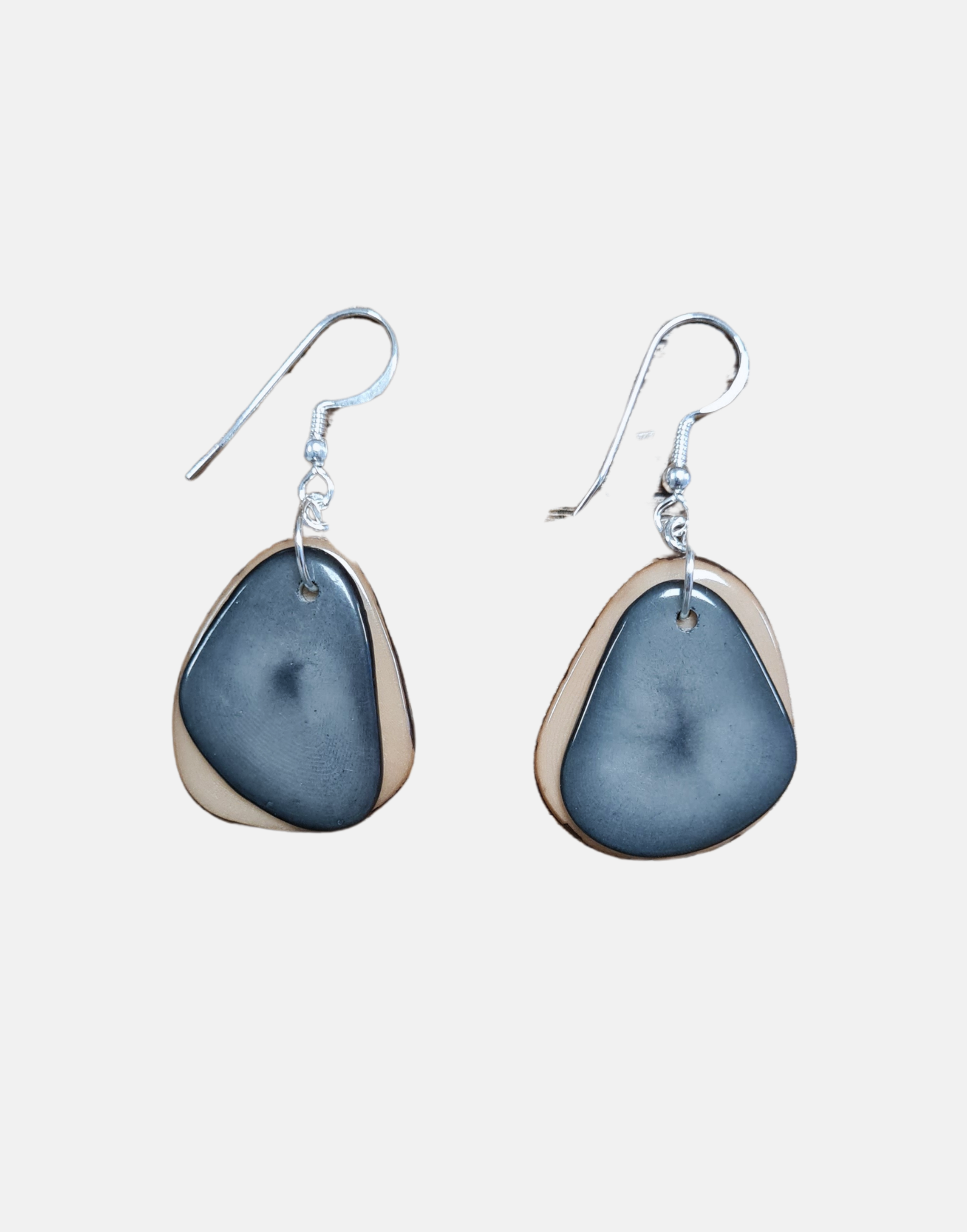 A pair of Secca Tagua Nut Earrings featuring organic vegetable ivory slices and sterling silver hooks, elegantly displayed in eco-friendly packaging.