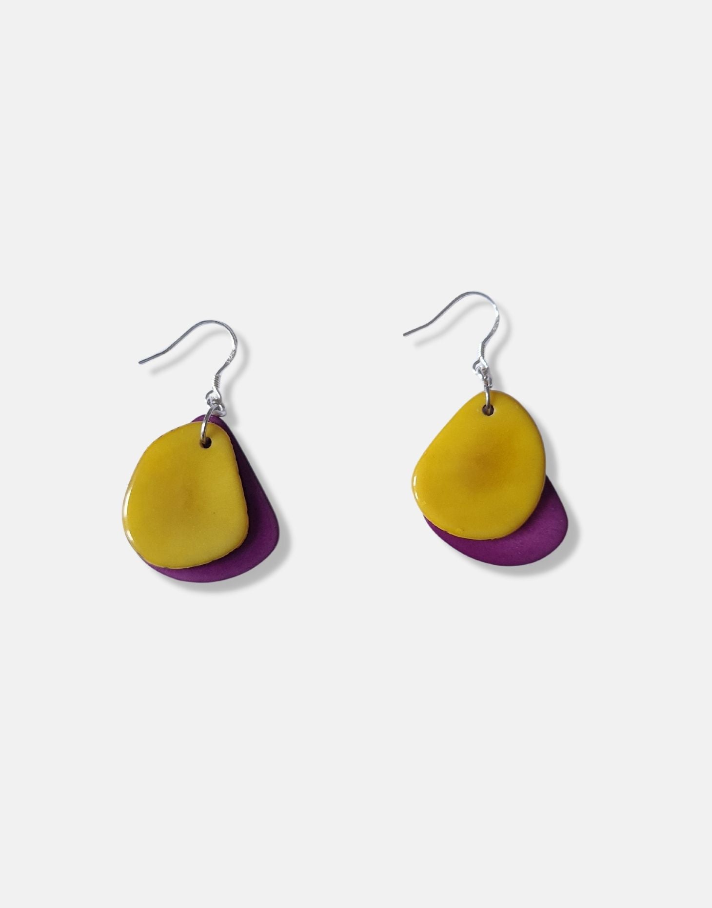 A pair of Secca Tagua Nut Earrings featuring organic vegetable ivory slices and sterling silver hooks, elegantly displayed in eco-friendly packaging.