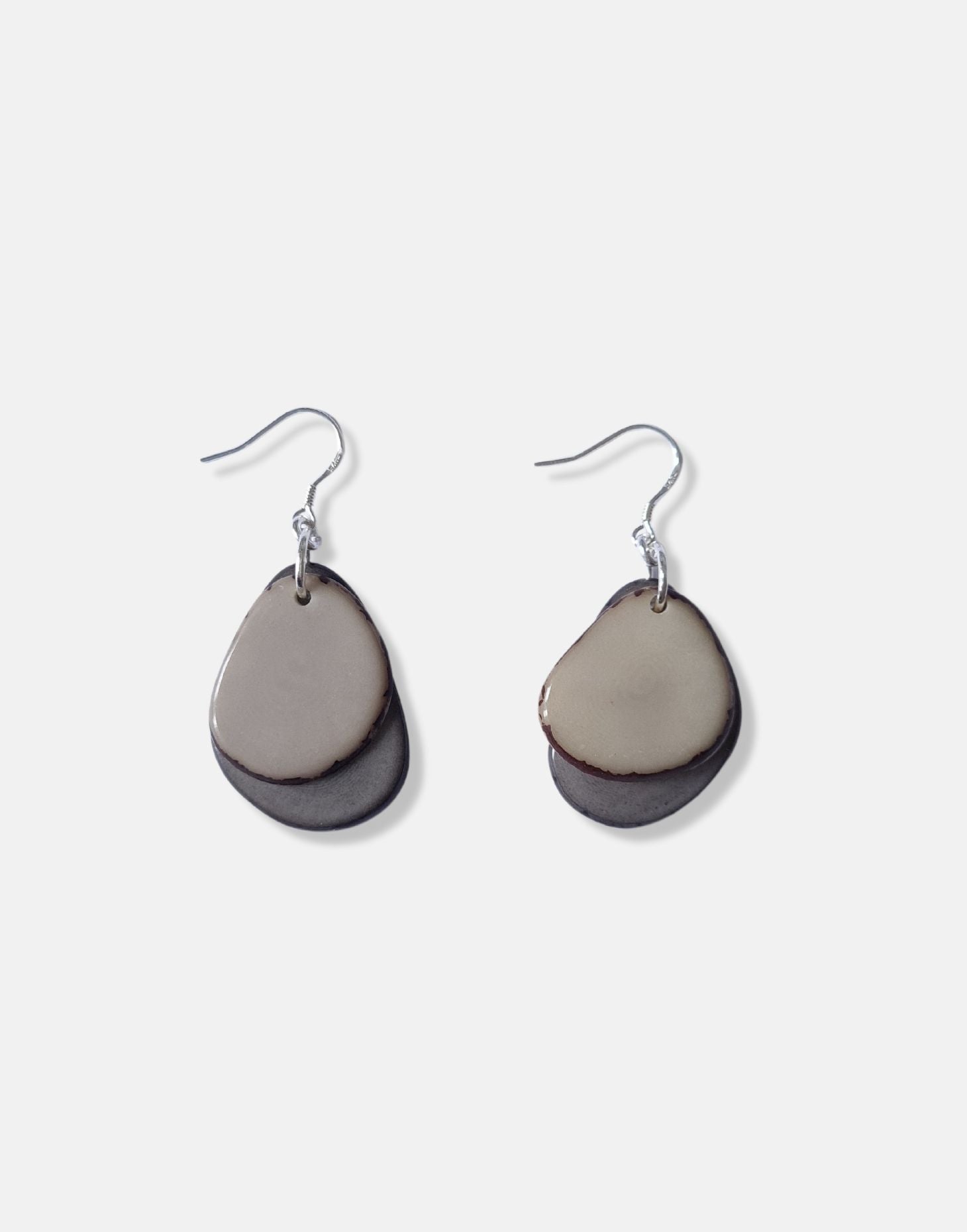 A pair of Secca Tagua Nut Earrings featuring organic vegetable ivory slices and sterling silver hooks, elegantly displayed in eco-friendly packaging.