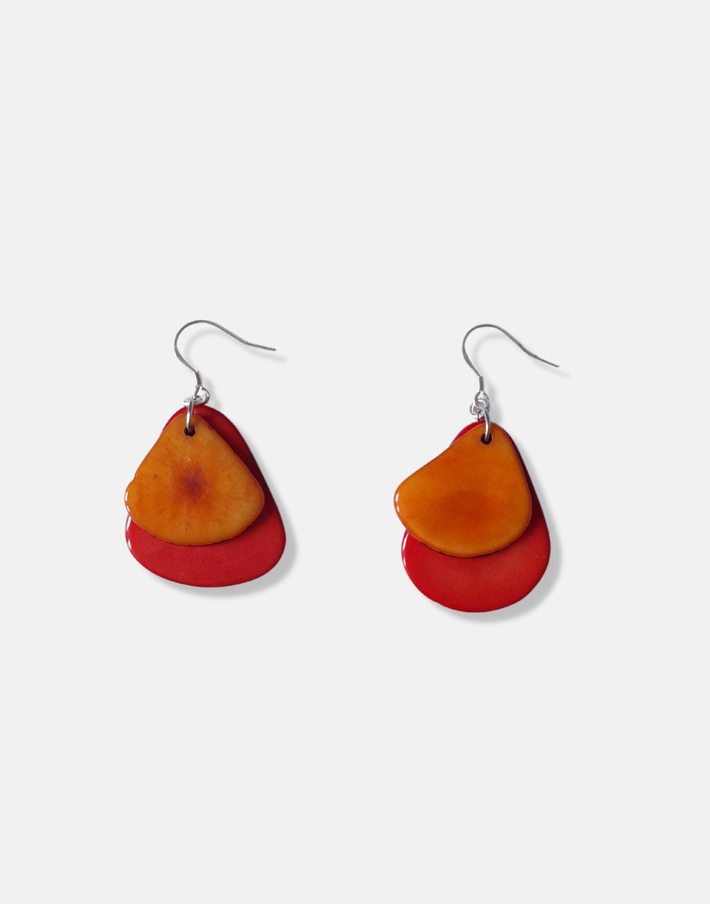 A pair of Secca Tagua Nut Earrings featuring organic vegetable ivory slices and sterling silver hooks, elegantly displayed in eco-friendly packaging.