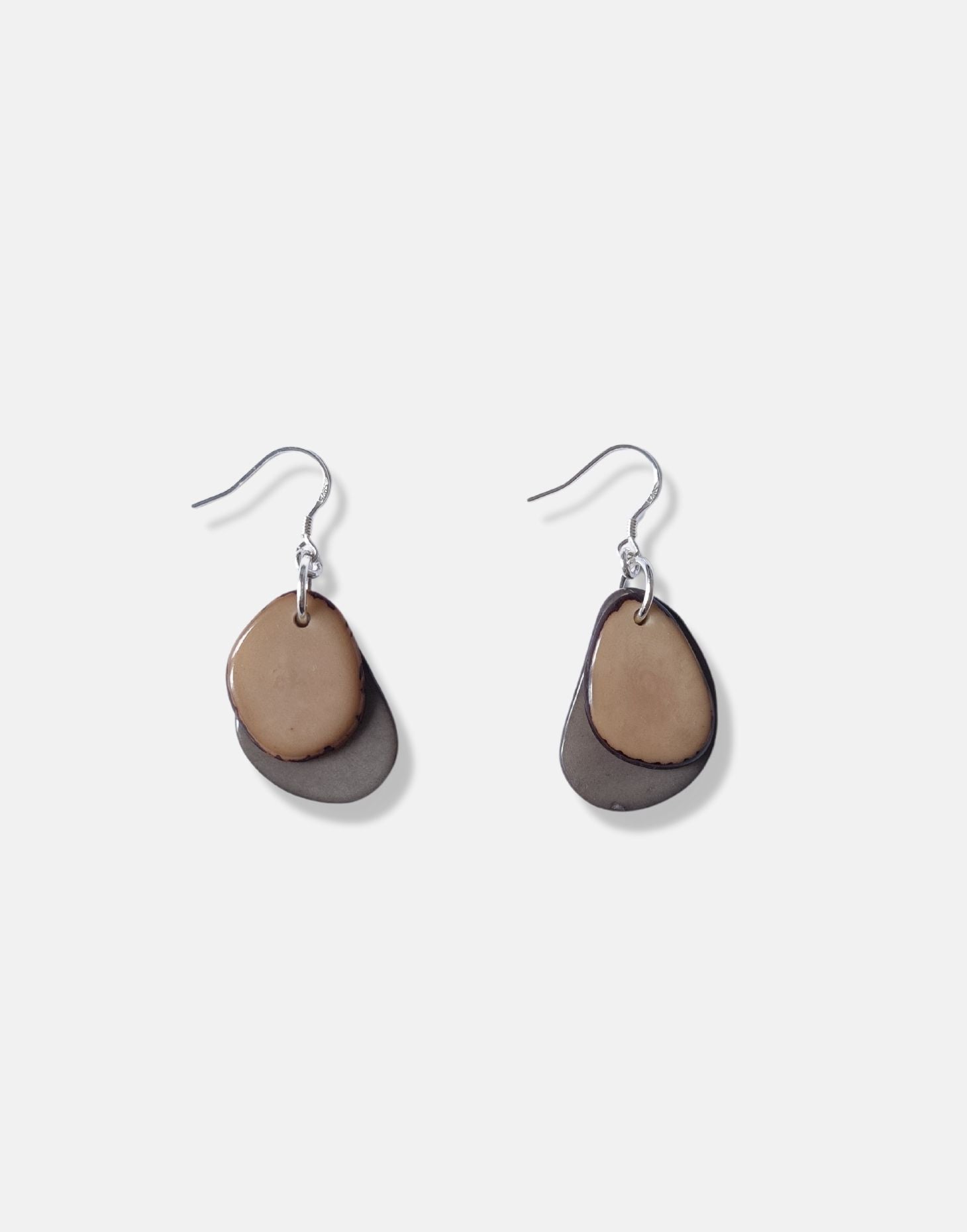 A pair of Secca Tagua Nut Earrings featuring organic vegetable ivory slices and sterling silver hooks, elegantly displayed in eco-friendly packaging.