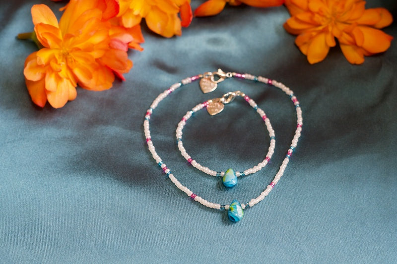 A colorful assortment of handcrafted seed bead necklaces displayed elegantly, showcasing various patterns and colors.