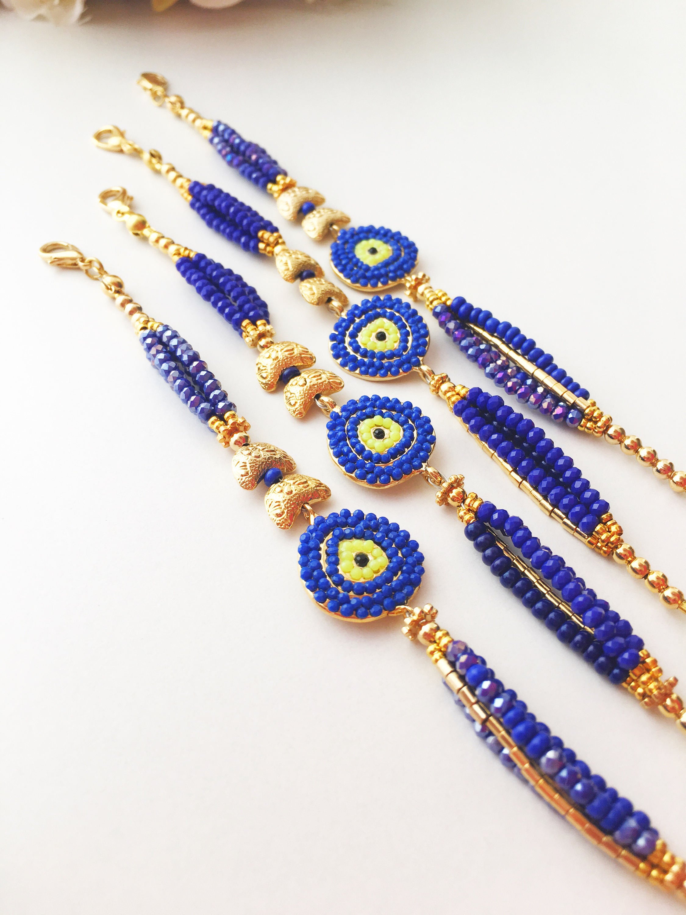 Handmade Seed Beads Evil Eye Bracelet featuring blue Miyuki beads and gold charm accents, symbolizing luck and protection.