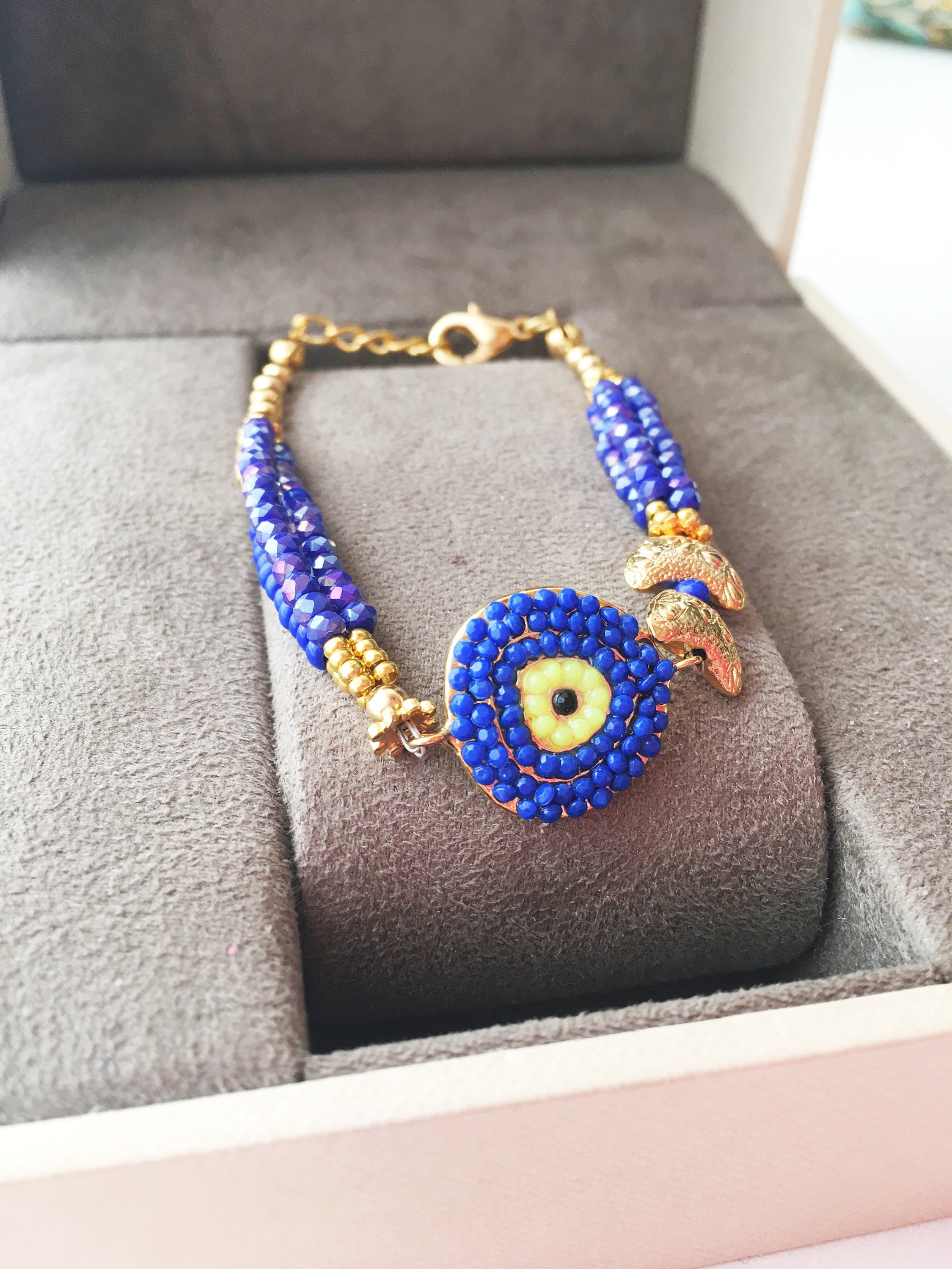 Handmade Seed Beads Evil Eye Bracelet featuring blue Miyuki beads and gold charm accents, symbolizing luck and protection.