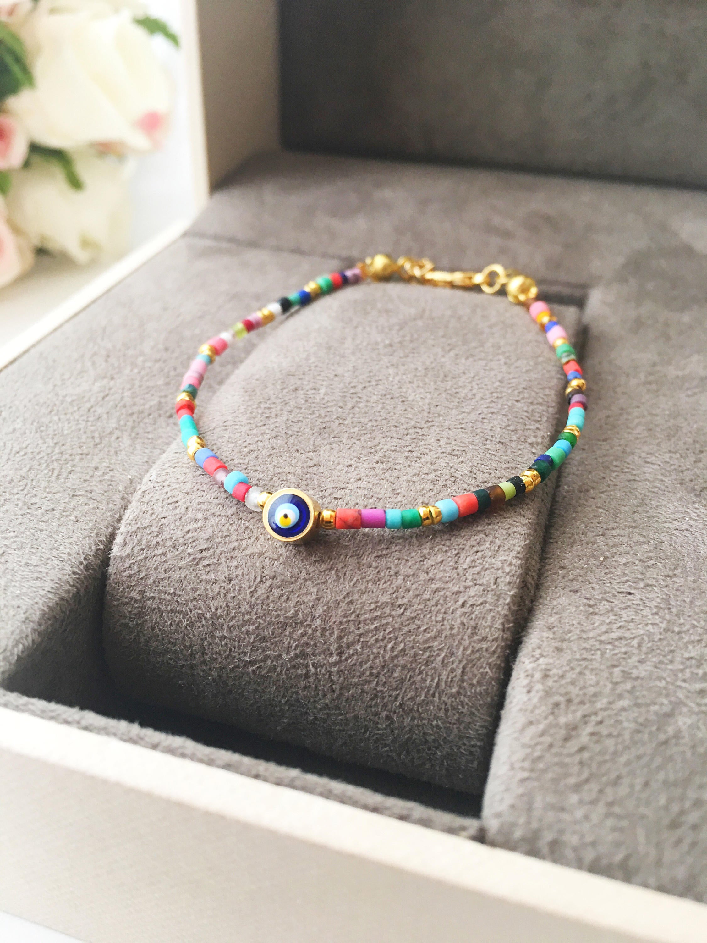 Handmade Seed Beads Evil Eye Bracelet featuring vibrant Miyuki beads and a protective charm, perfect for everyday wear.