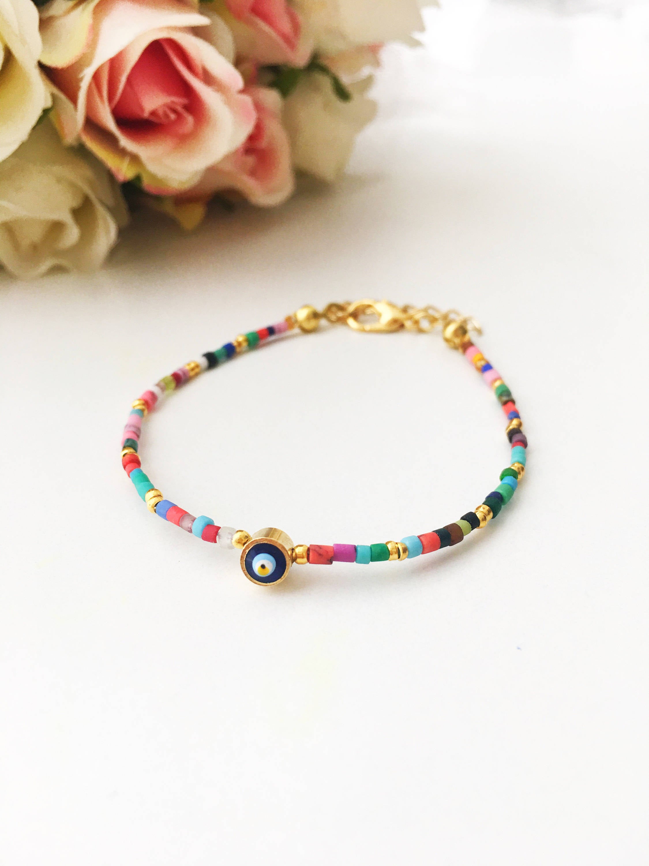 Handmade Seed Beads Evil Eye Bracelet featuring vibrant Miyuki beads and a protective charm, perfect for everyday wear.