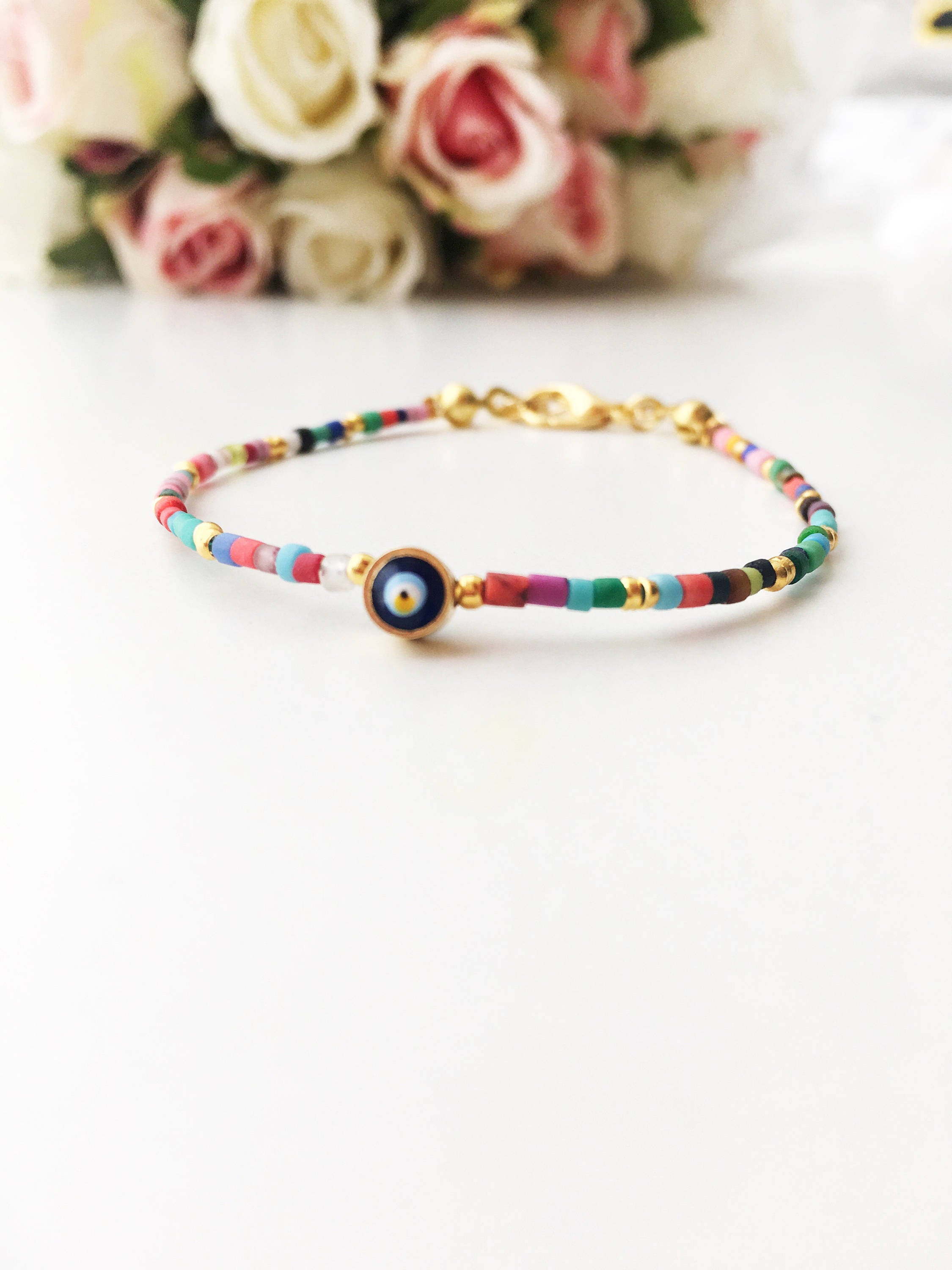 Handmade Seed Beads Evil Eye Bracelet featuring vibrant Miyuki beads and a protective charm, perfect for everyday wear.