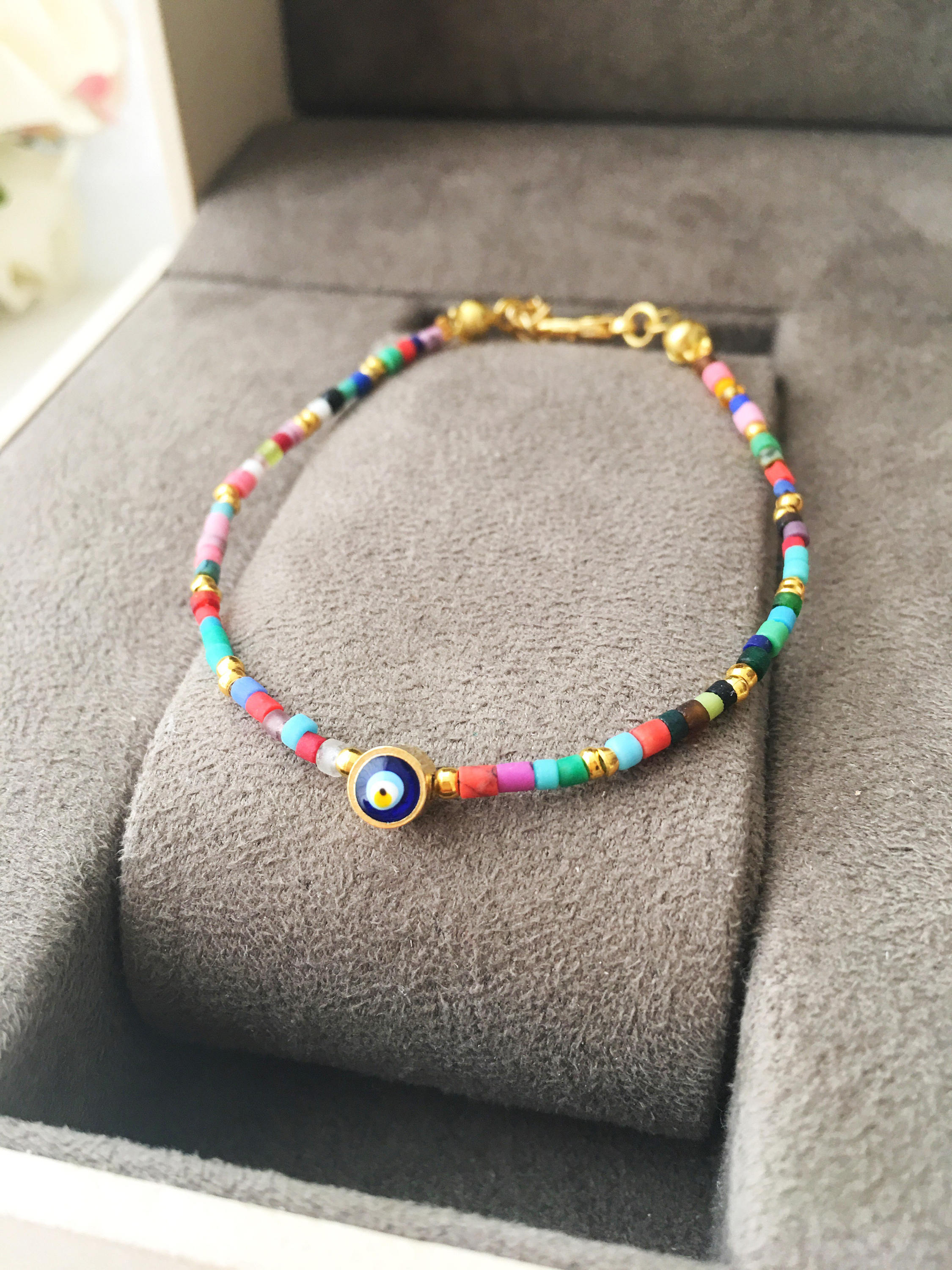 Handmade Seed Beads Evil Eye Bracelet featuring vibrant Miyuki beads and a protective charm, perfect for everyday wear.