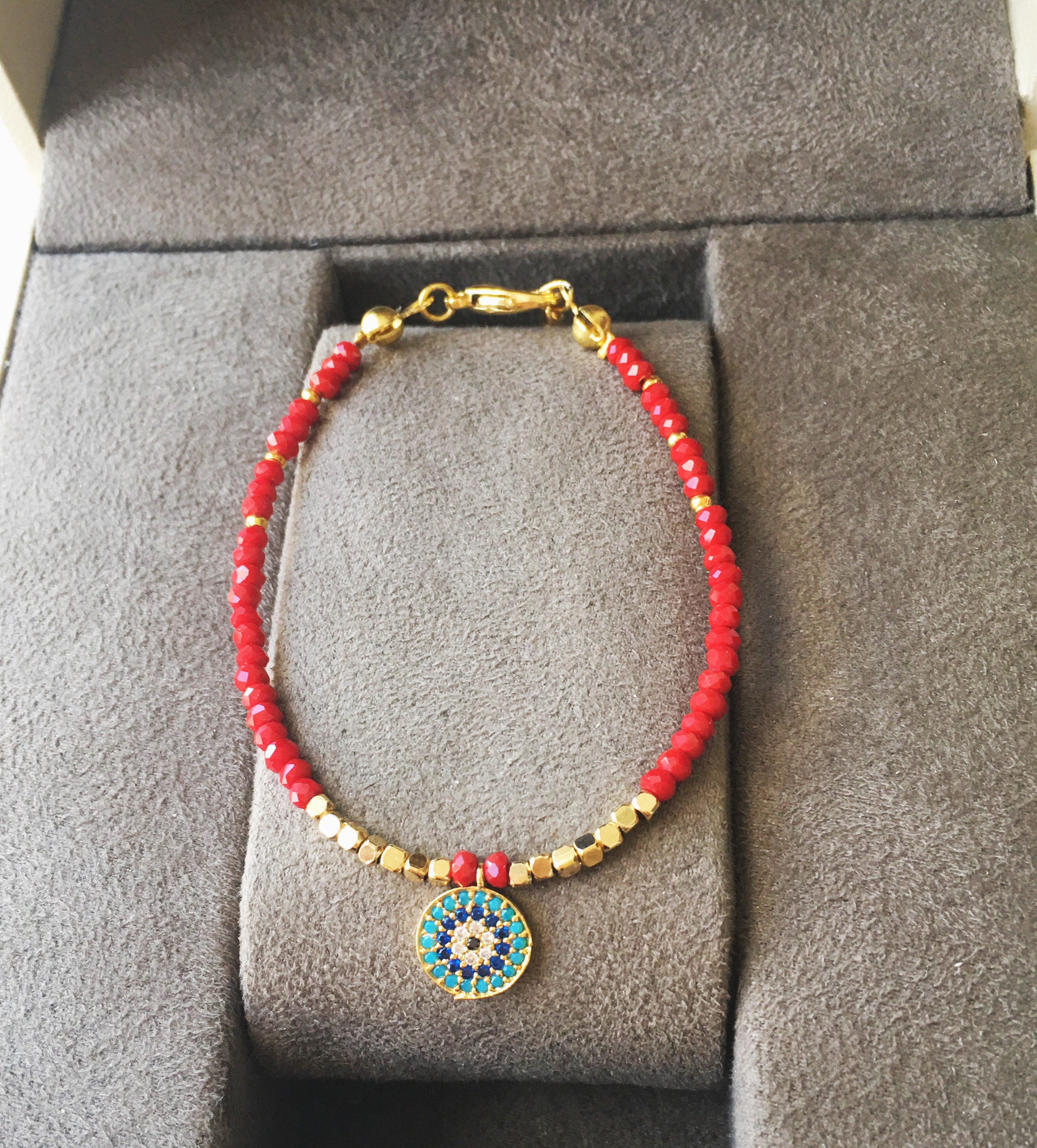 Handmade Miyuki Evil Eye Bracelet featuring vibrant turquoise, red, and blue seed beads with a protective charm.