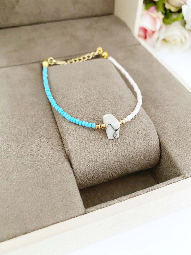 A beautifully handcrafted Seed Beads Bracelet featuring Miyuki beads in blue and white colors, showcasing its dainty design and vibrant appearance.