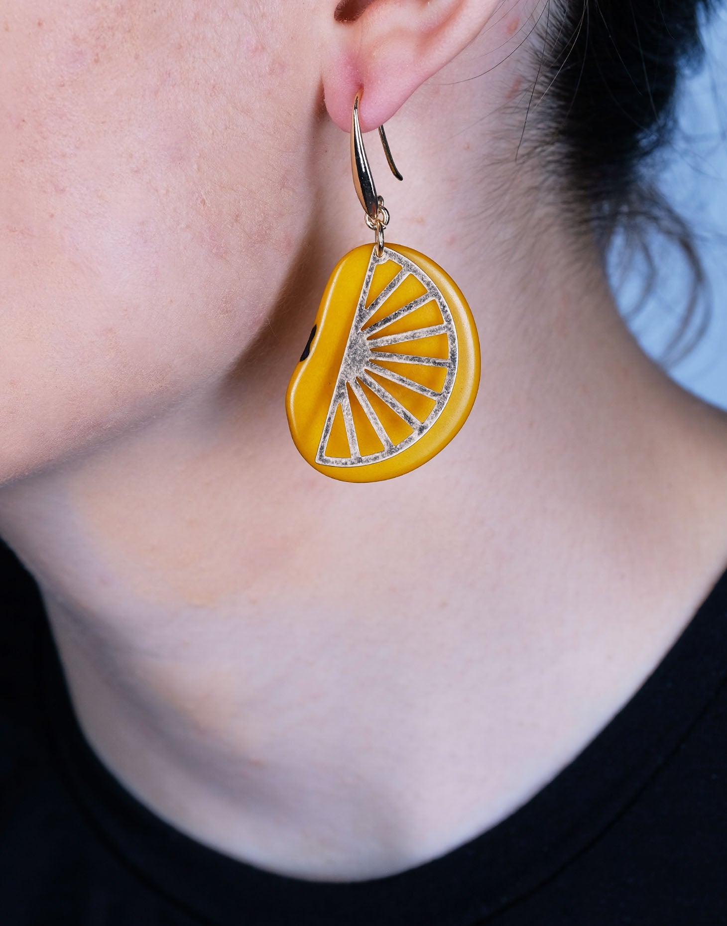 Segment Tagua Earrings featuring vibrant colors and raw brass charm, showcasing eco-friendly design.