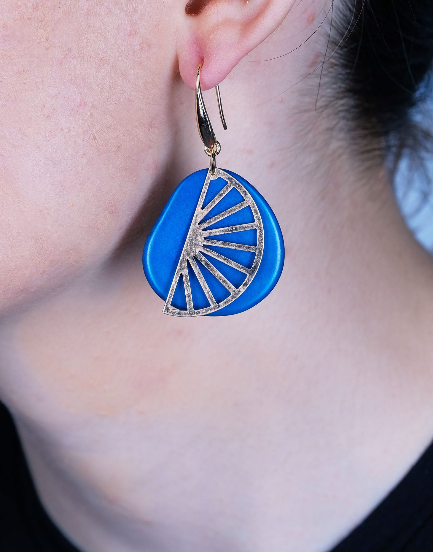 Segment Tagua Earrings featuring vibrant colors and raw brass charm, showcasing eco-friendly design.