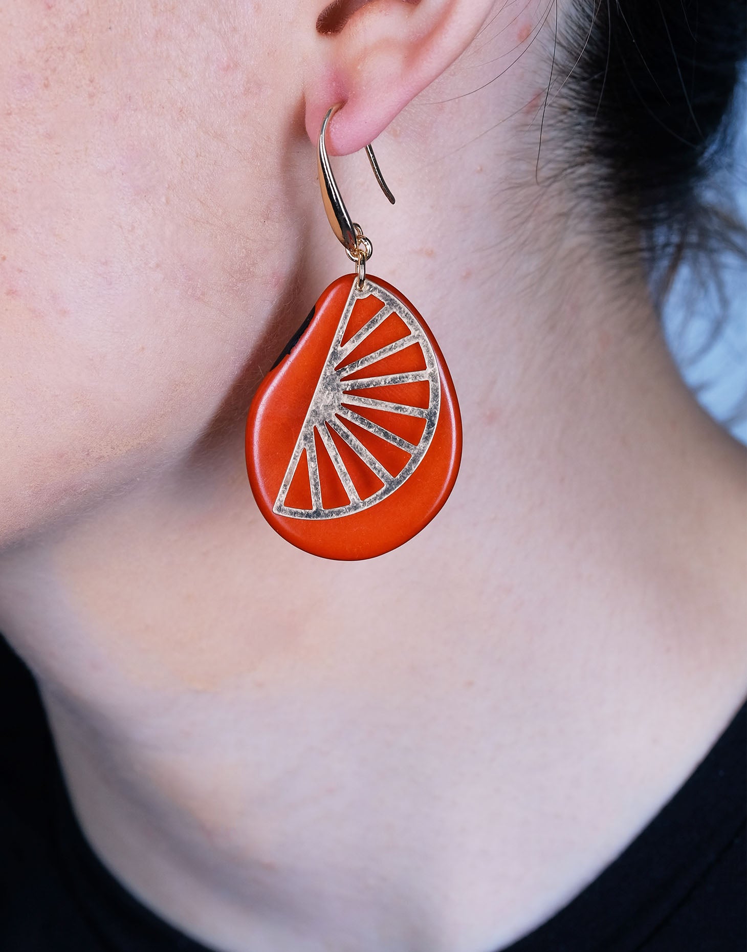 Segment Tagua Earrings featuring vibrant colors and raw brass charm, showcasing eco-friendly design.