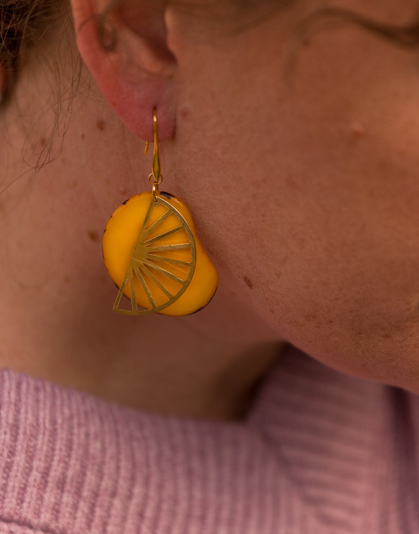 Segment Tagua Earrings featuring vibrant colors and raw brass charm, showcasing eco-friendly design.