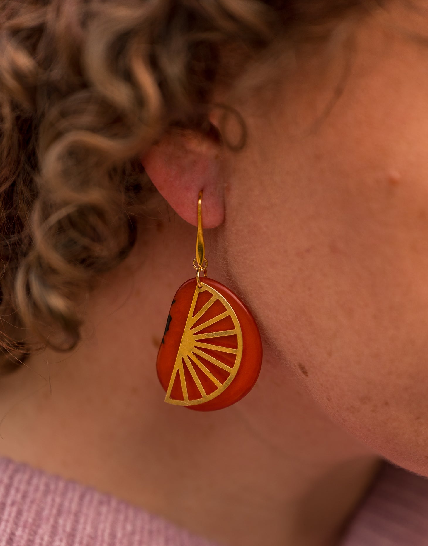 Segment Tagua Earrings featuring vibrant colors and raw brass charm, showcasing eco-friendly design.