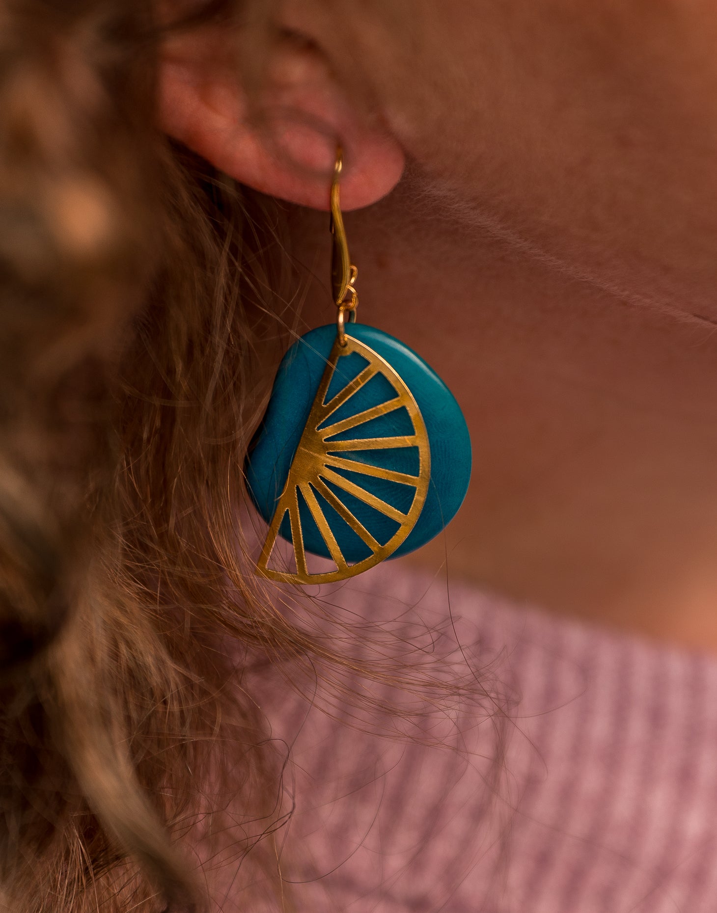 Segment Tagua Earrings featuring vibrant colors and raw brass charm, showcasing eco-friendly design.