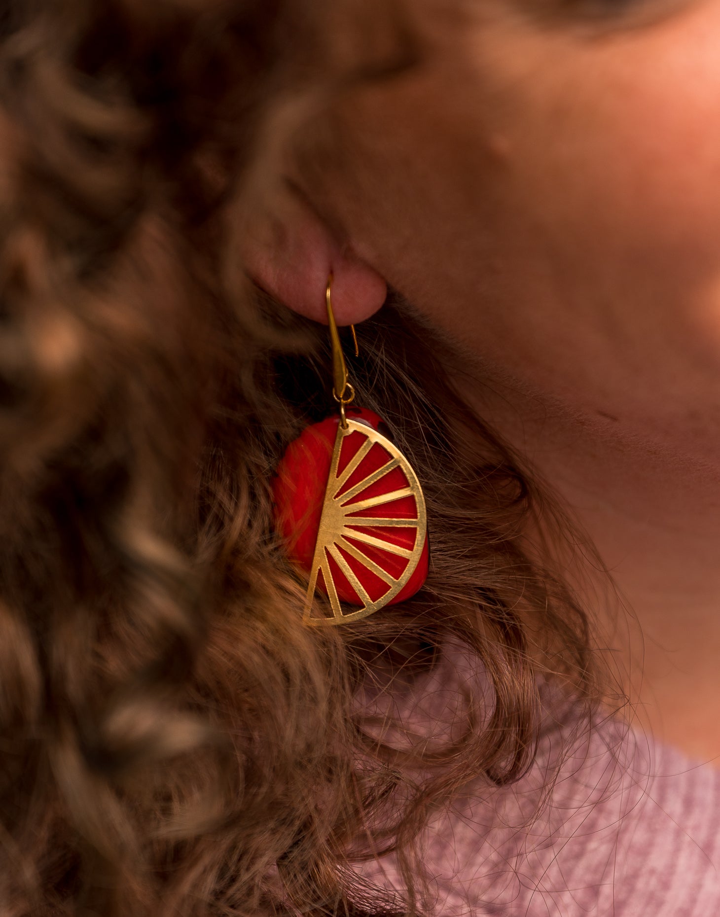 Segment Tagua Earrings featuring vibrant colors and raw brass charm, showcasing eco-friendly design.