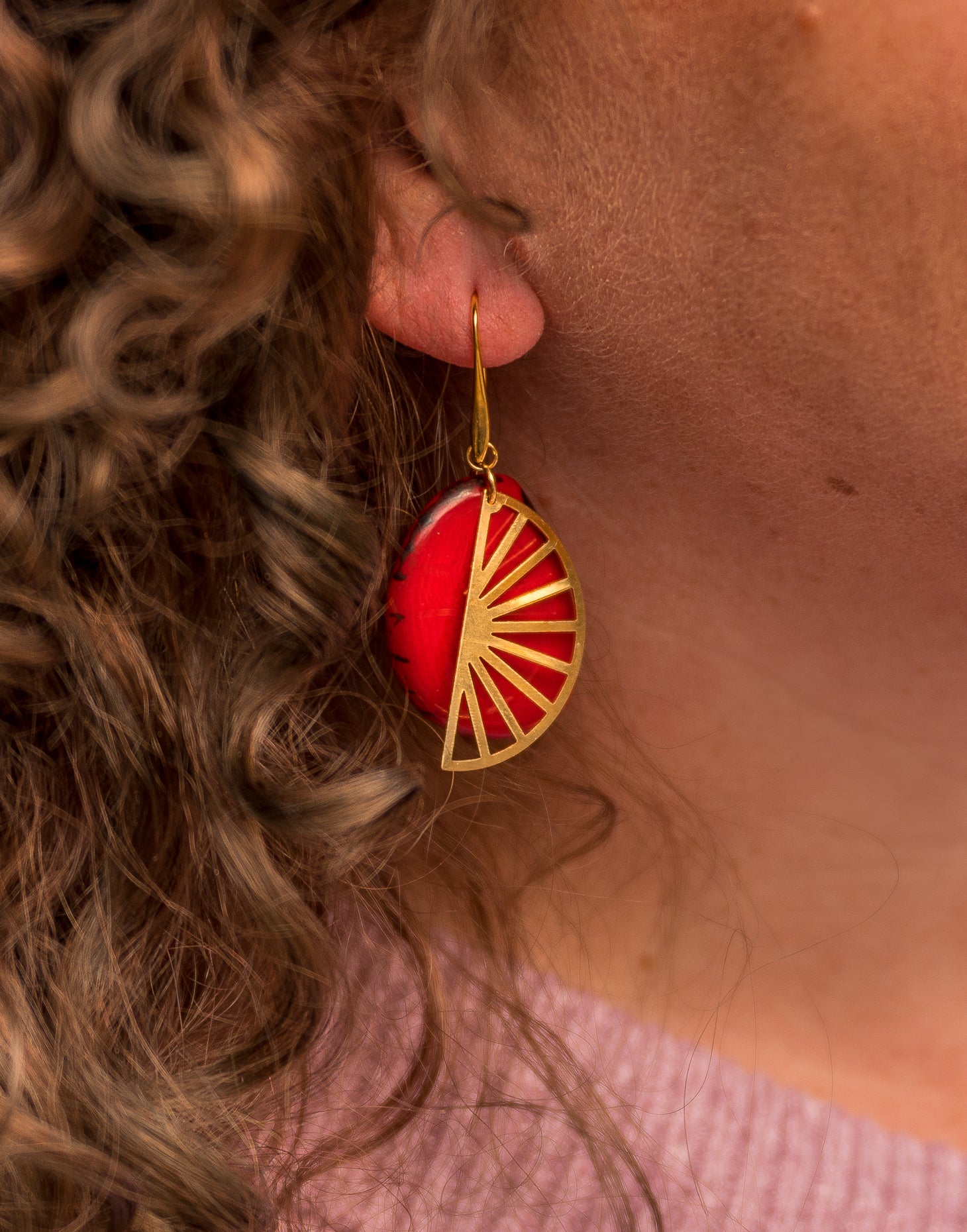 Segment Tagua Earrings featuring vibrant colors and raw brass charm, showcasing eco-friendly design.