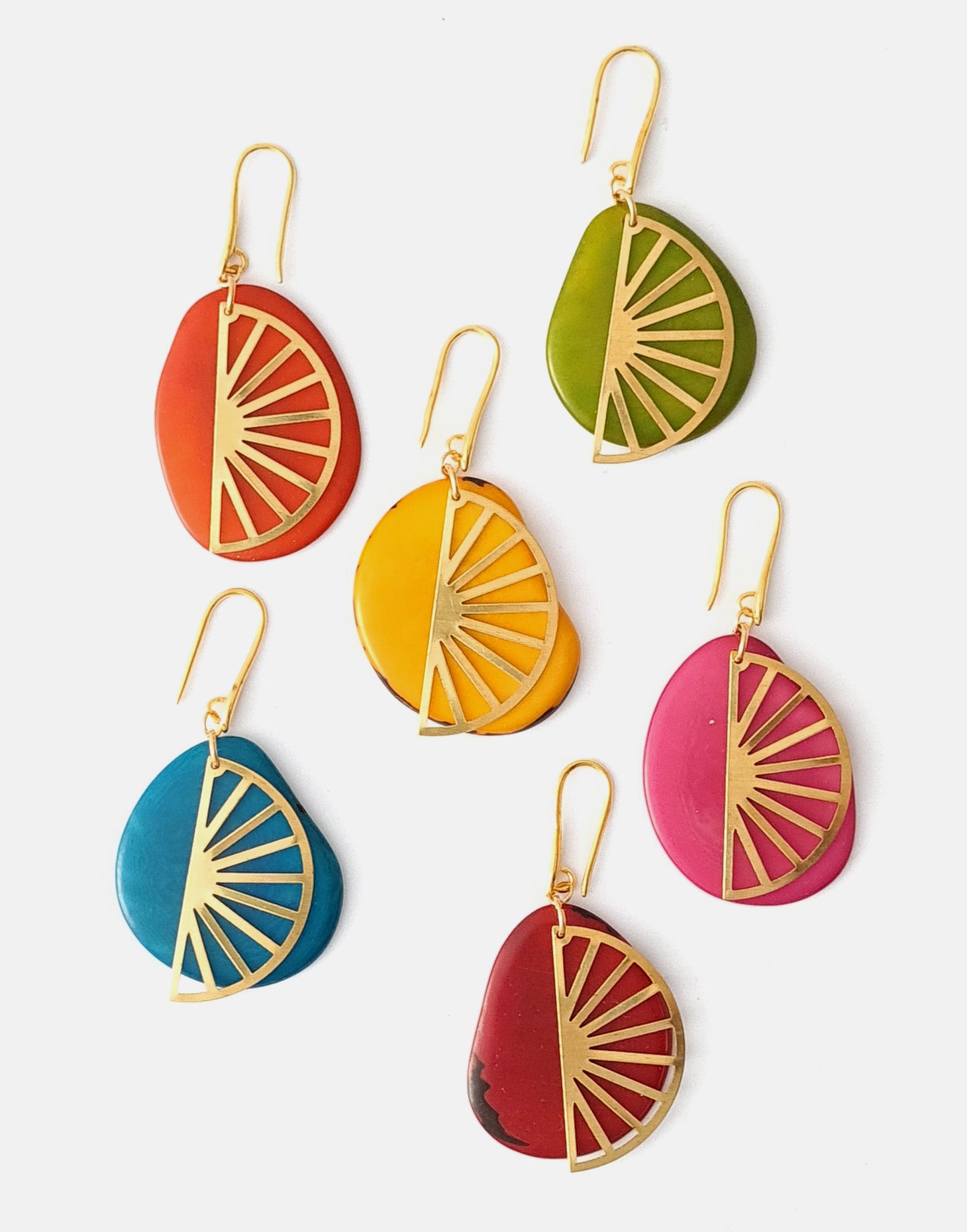 Segment Tagua Earrings featuring vibrant colors and raw brass charm, showcasing eco-friendly design.