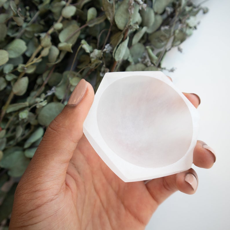 A hexagon-shaped Selenite Charging Bowl, showcasing its translucent and smooth surface, ideal for cleansing gemstones.