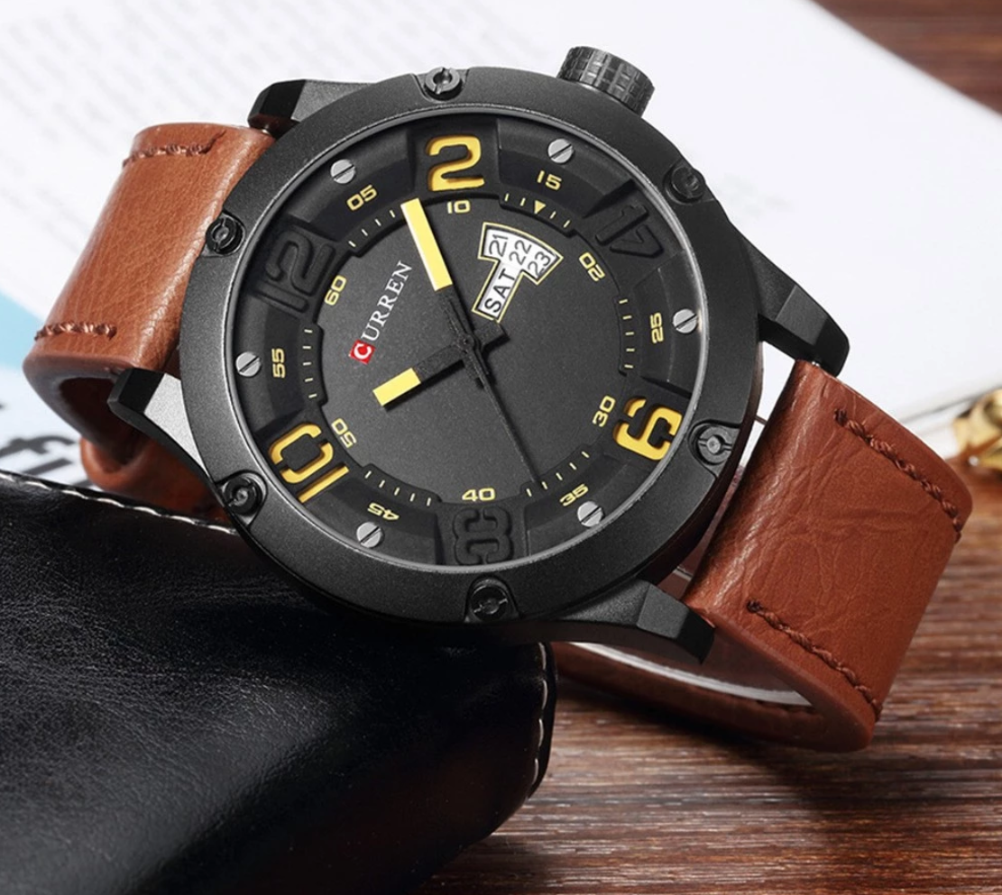 SENSATIONAL Curren Leather watch featuring a black steel cover and yellow accents on the hands, with a stylish leather strap.