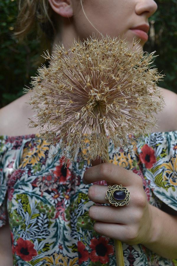 A detailed image of the Sensual Stone Ring featuring a semi-precious stone set in an intricate brass design, showcasing its elegance and craftsmanship.