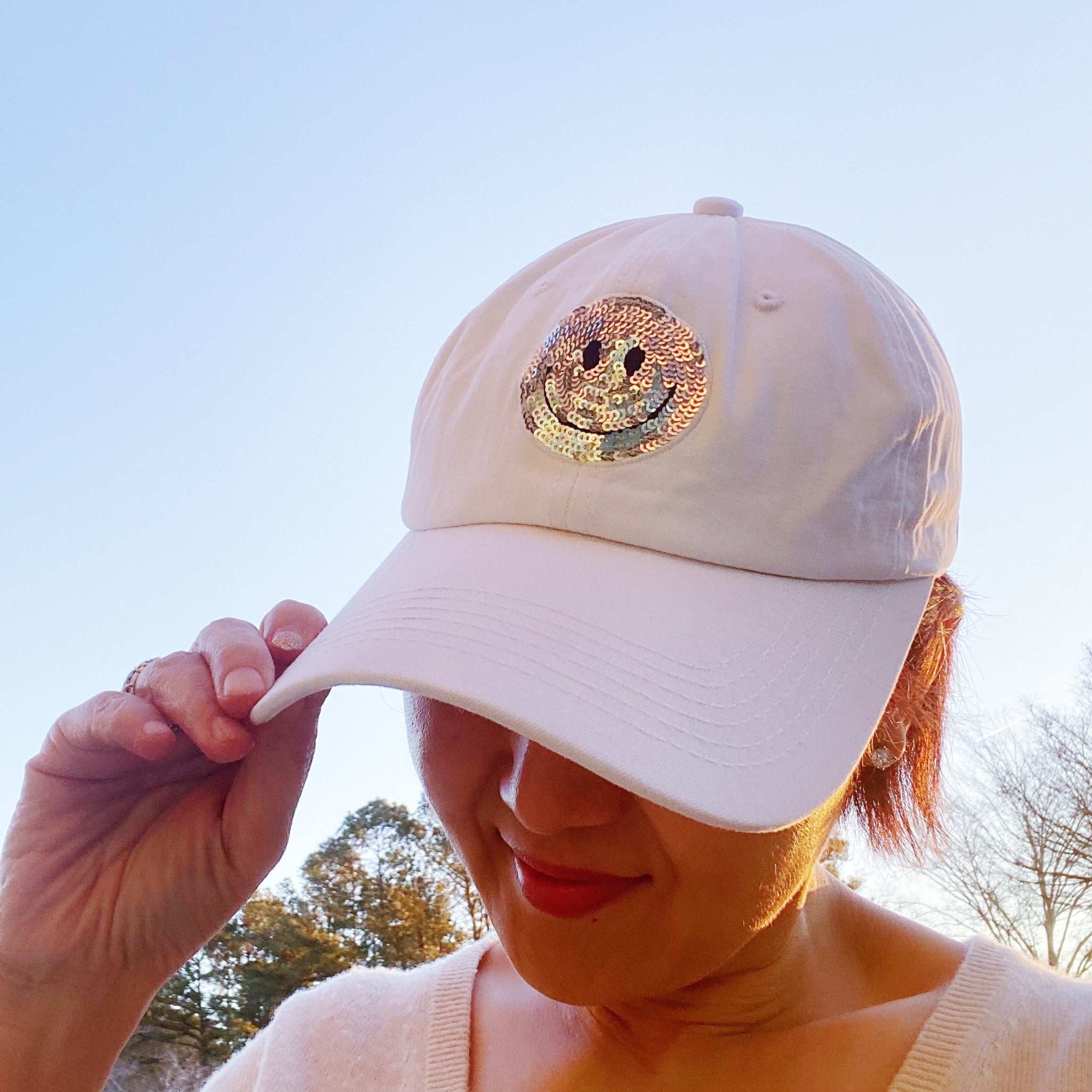 A stylish Sequin Patch Happy Ball Cap featuring a cheerful sequin happy face patch on a washed finish fabric, perfect for casual wear.