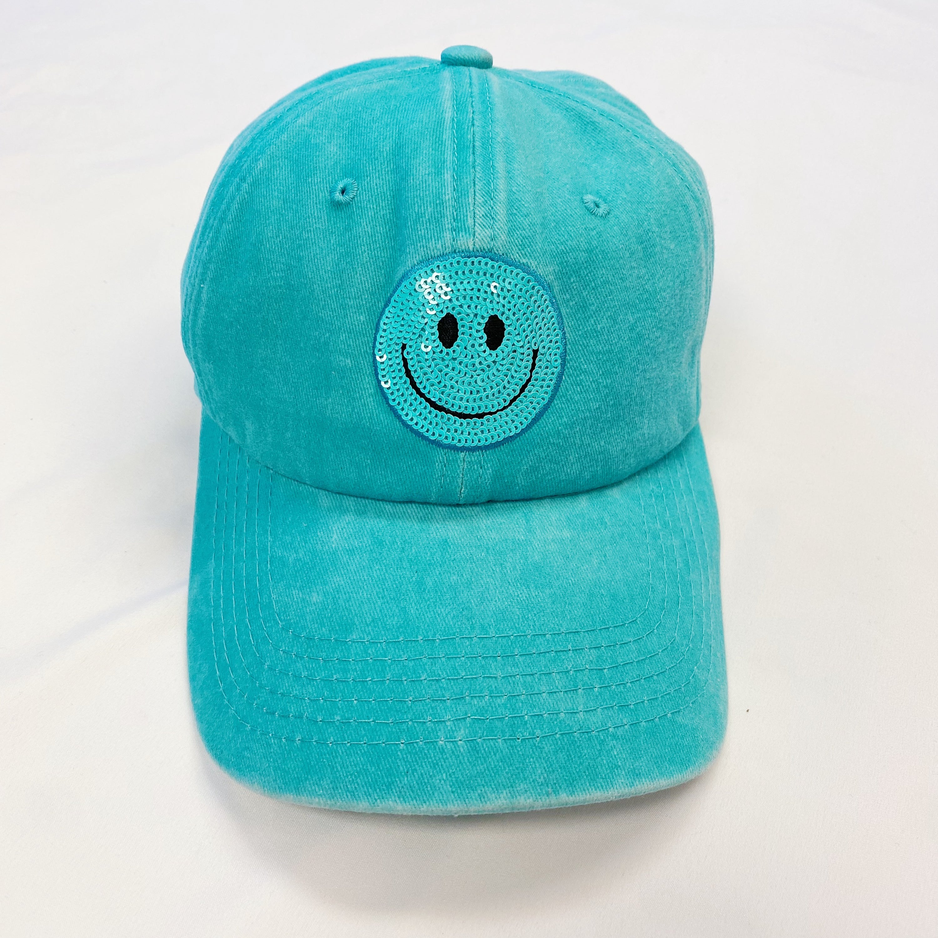 A stylish Sequin Patch Happy Ball Cap featuring a cheerful sequin happy face patch on a washed finish fabric, perfect for casual wear.