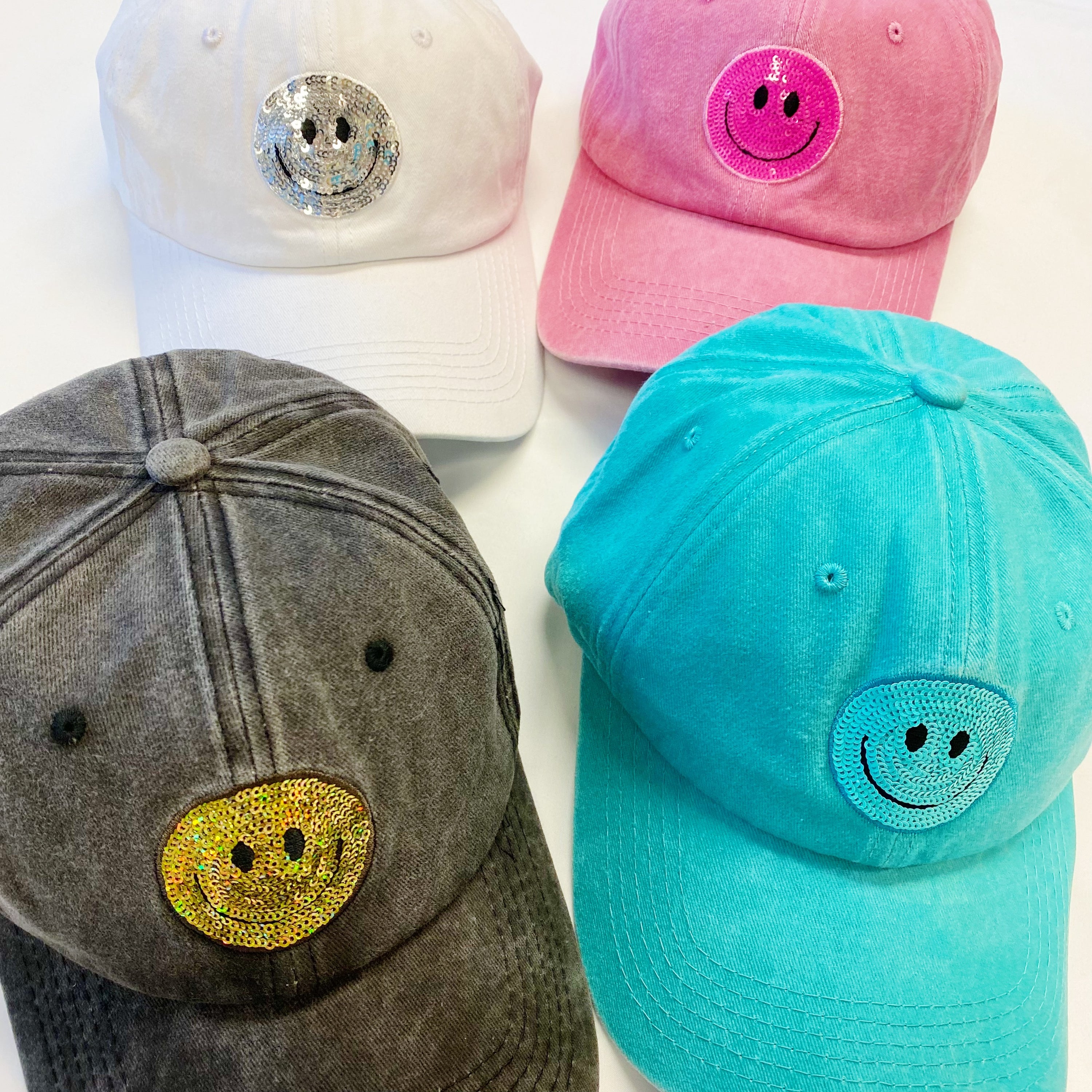 A stylish Sequin Patch Happy Ball Cap featuring a cheerful sequin happy face patch on a washed finish fabric, perfect for casual wear.