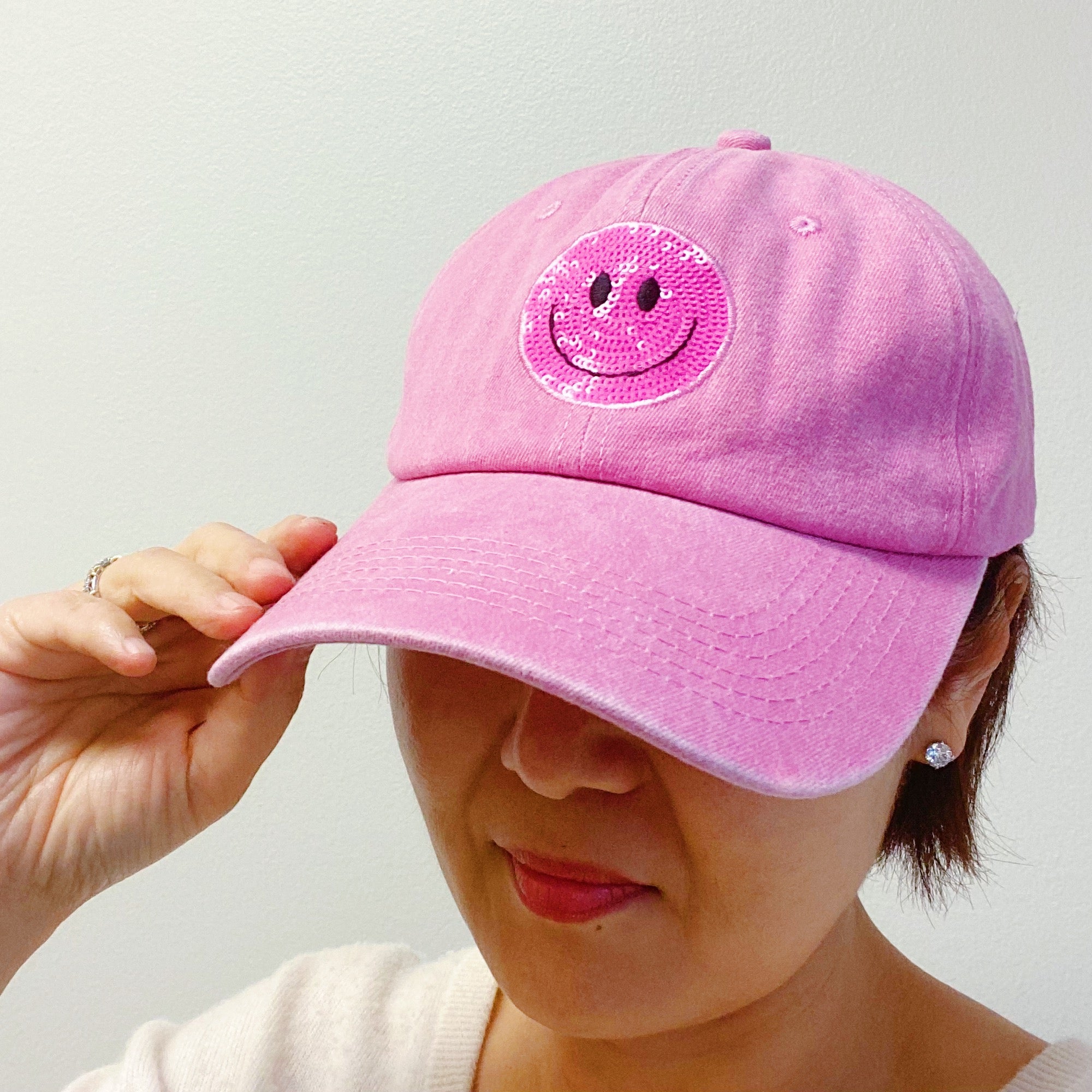 A stylish Sequin Patch Happy Ball Cap featuring a cheerful sequin happy face patch on a washed finish fabric, perfect for casual wear.