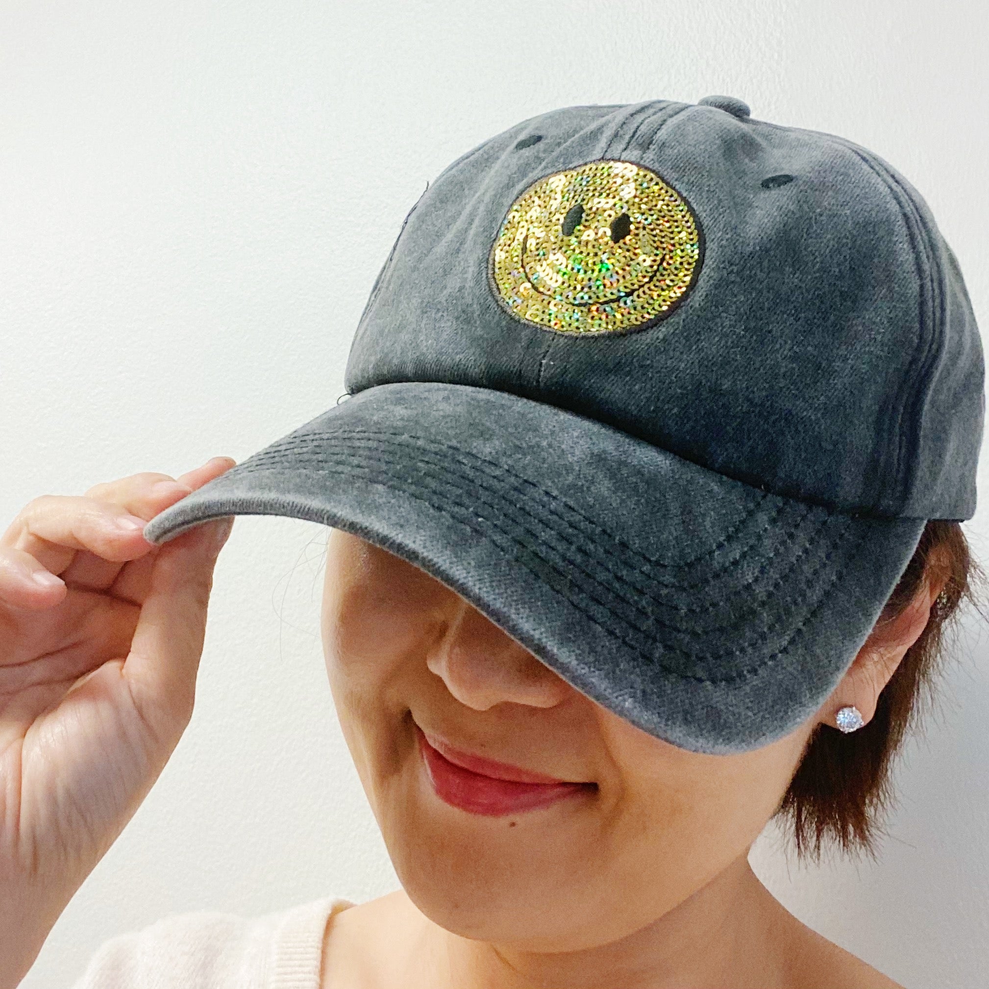 A stylish Sequin Patch Happy Ball Cap featuring a cheerful sequin happy face patch on a washed finish fabric, perfect for casual wear.