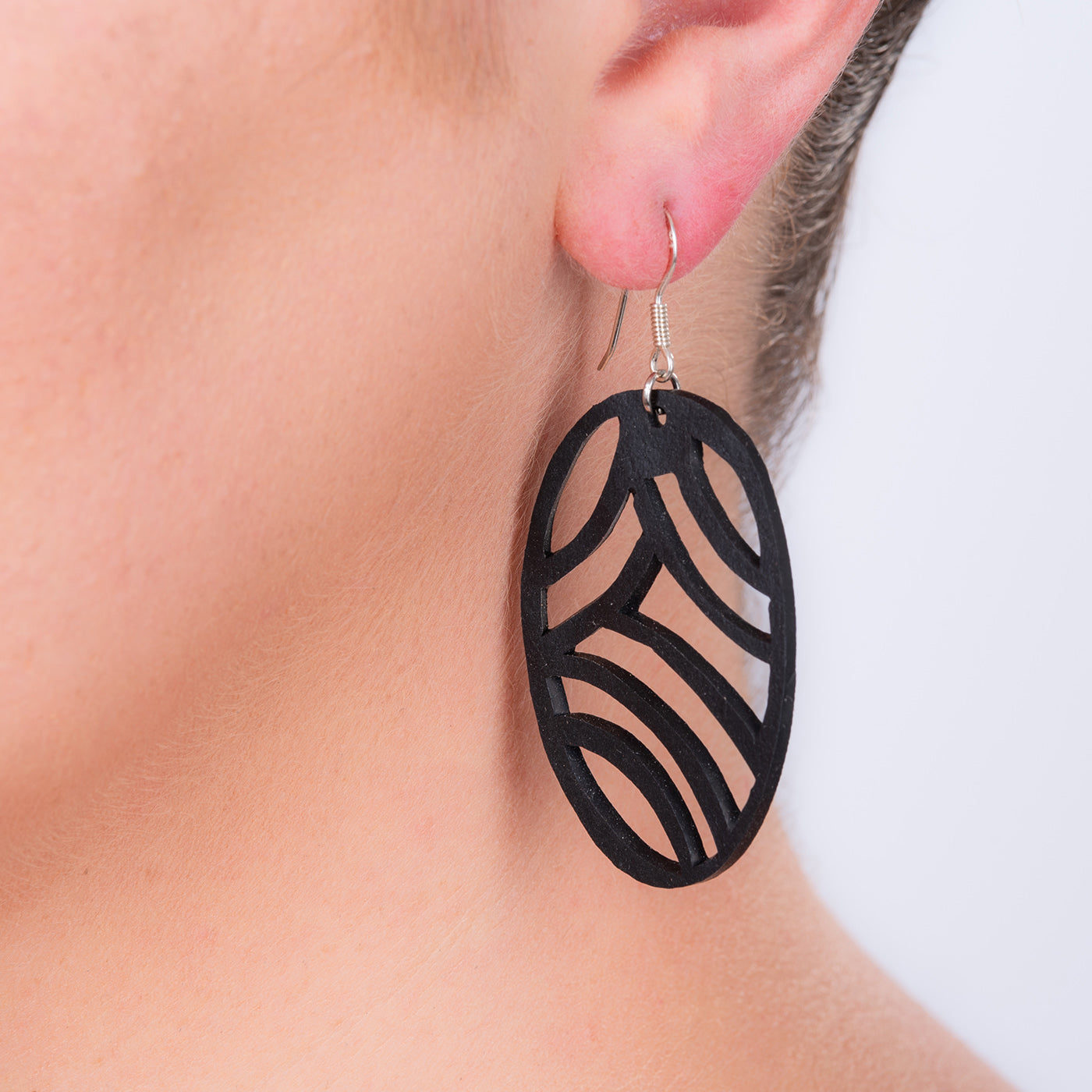 Seraphine (I) Recycled Rubber Earrings featuring a wave-like design, handcrafted from reclaimed tyre inner tubes with sterling silver hooks.