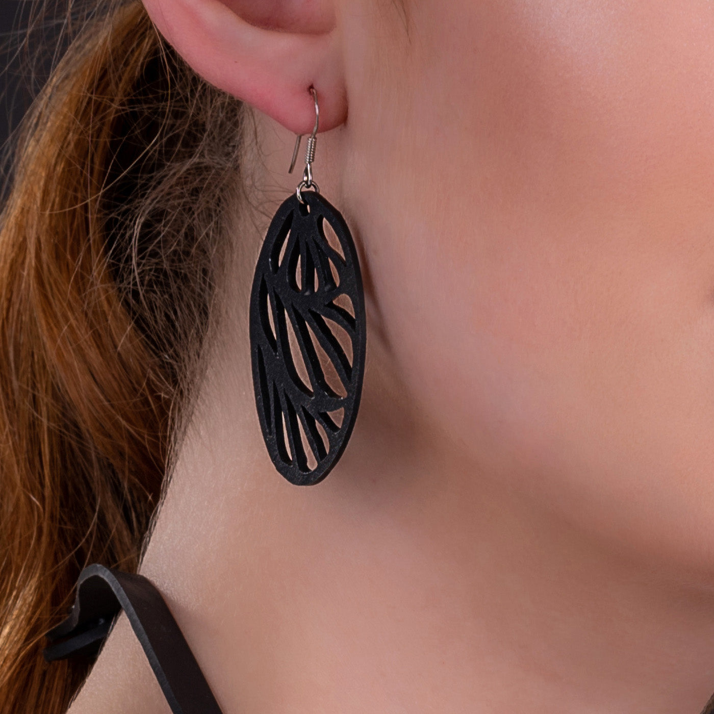 Seraphine (III) Recycled Rubber Oval Earrings featuring a bold fan motif, handcrafted from reclaimed tyre inner tubes.