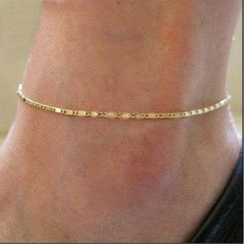 A stylish gold anklet with a geometric design, featuring an adjustable length for a perfect fit.