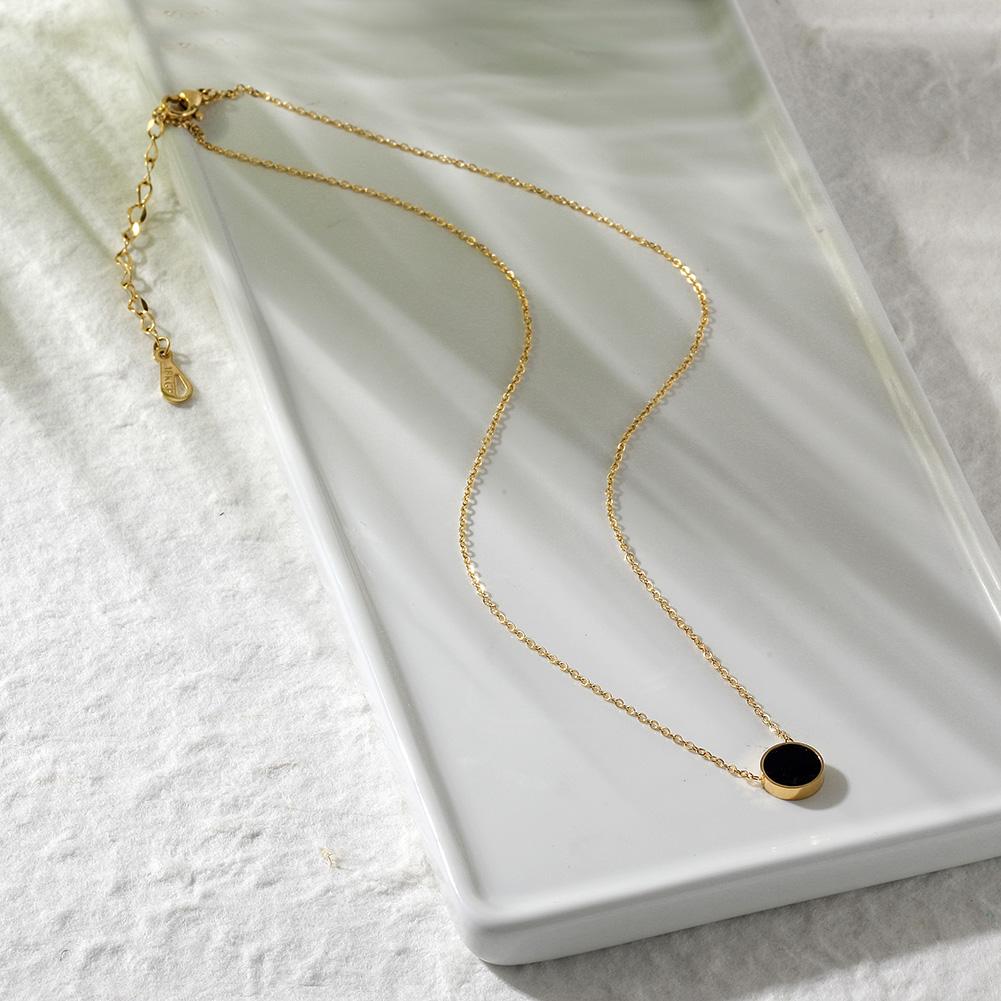 A beautiful double-sided Shell Acrylic Pendant featuring natural shell on one side and black acrylic on the other, adorned with a delicate gold chain.