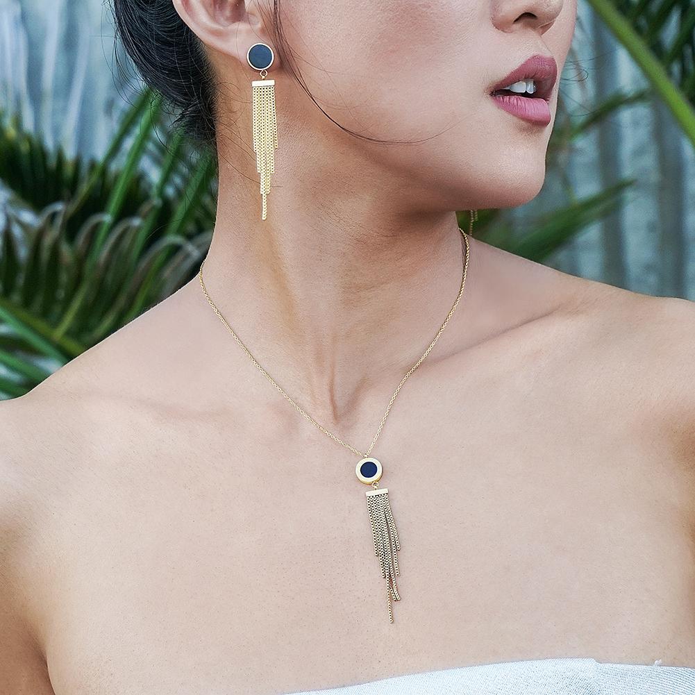 SHELL ACRYLIC TASSEL PENDANT featuring natural shell and black acrylic with 14k gold accents on a delicate chain.