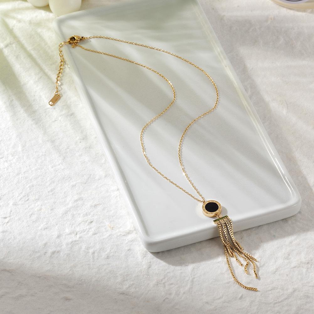 SHELL ACRYLIC TASSEL PENDANT featuring natural shell and black acrylic with 14k gold accents on a delicate chain.