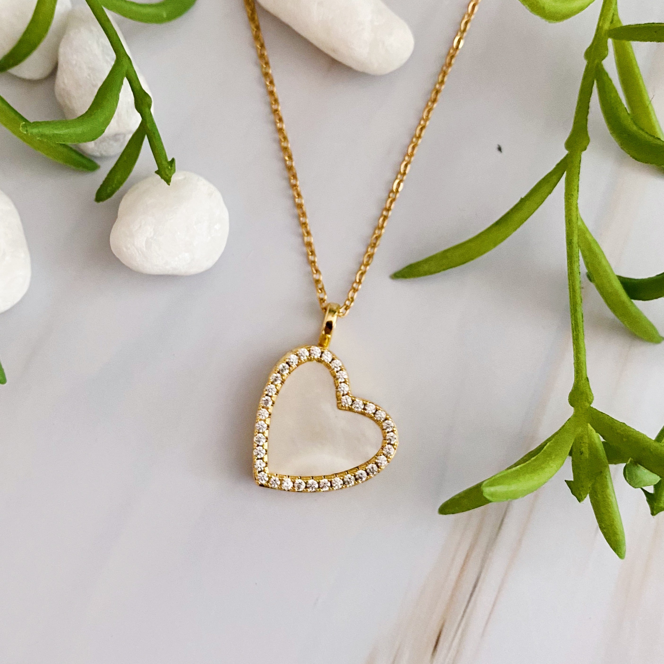 Elegant Shell Heart Locket Pendant Necklace with mother of pearl and gold plating, featuring a delicate design and adjustable chain.