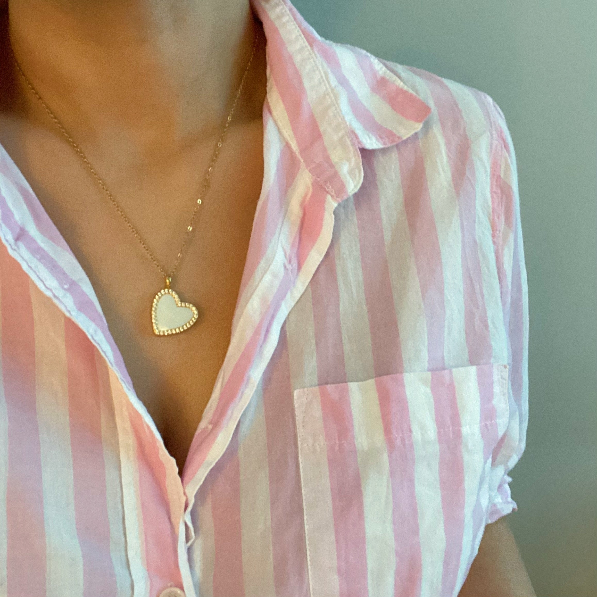 Elegant Shell Heart Locket Pendant Necklace with mother of pearl and gold plating, featuring a delicate design and adjustable chain.