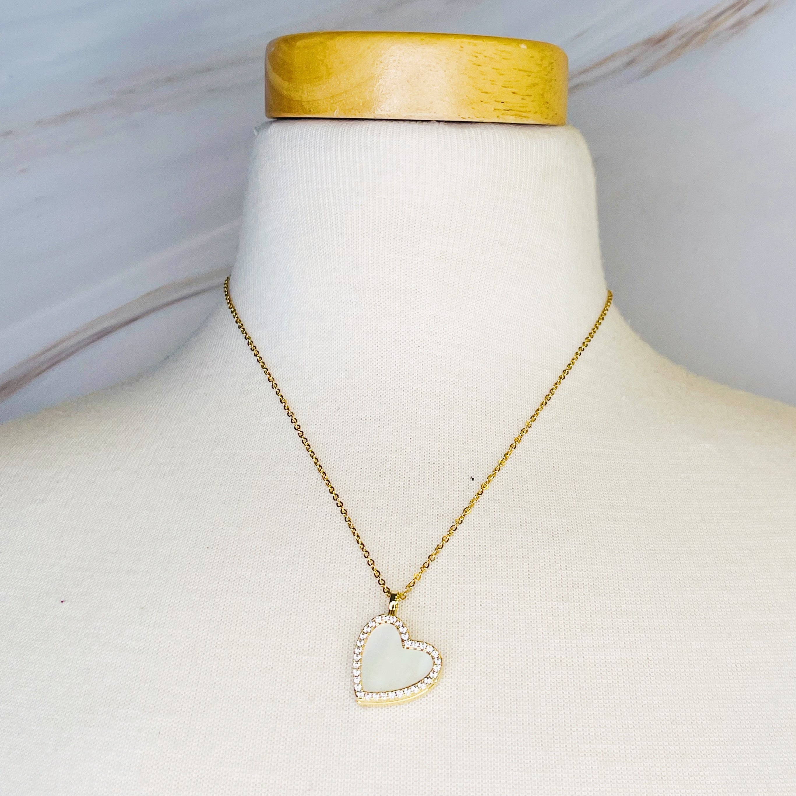 Elegant Shell Heart Locket Pendant Necklace with mother of pearl and gold plating, featuring a delicate design and adjustable chain.