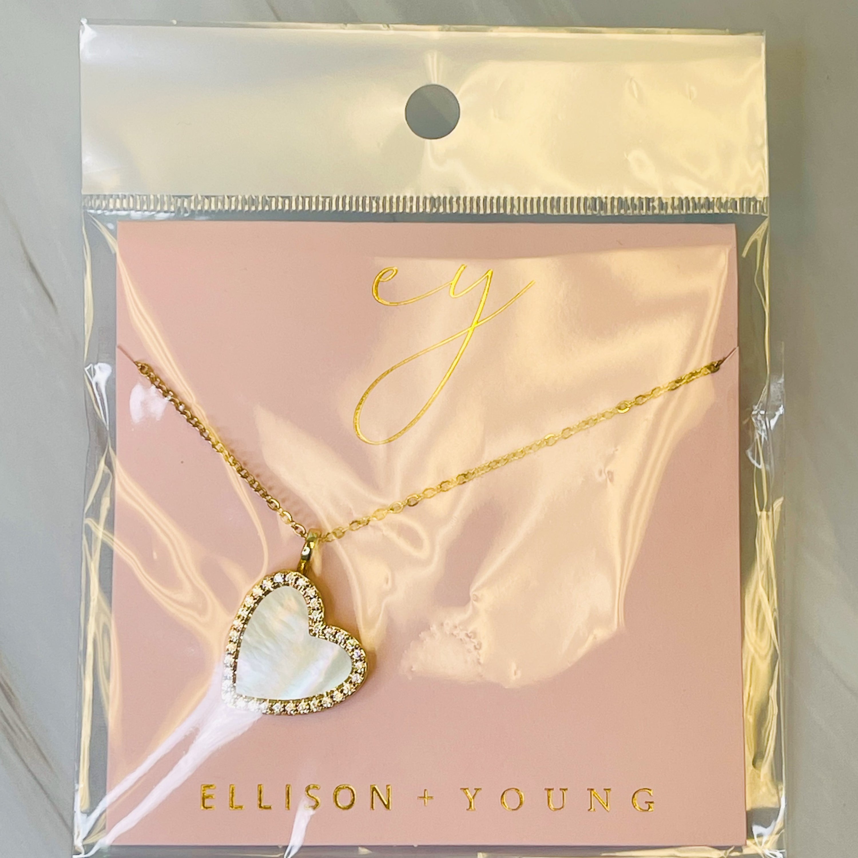 Elegant Shell Heart Locket Pendant Necklace with mother of pearl and gold plating, featuring a delicate design and adjustable chain.