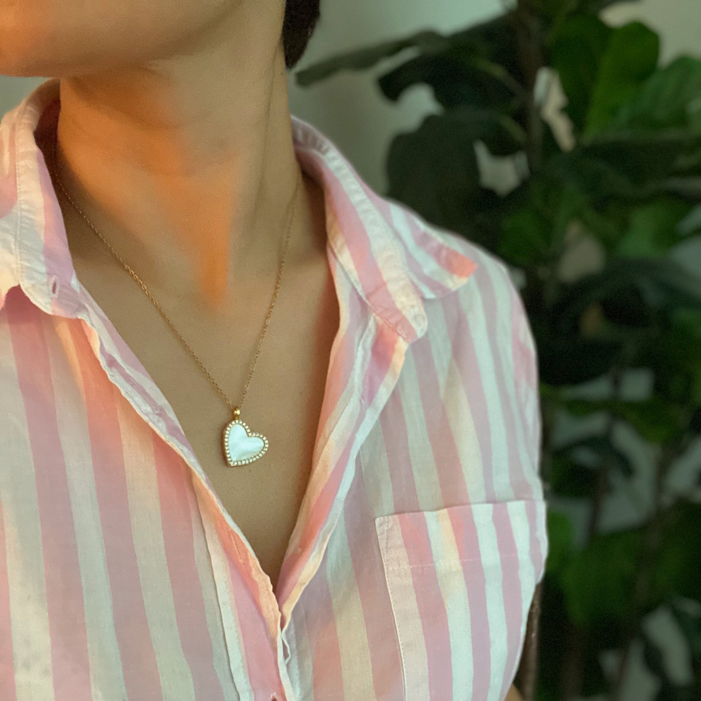 Elegant Shell Heart Locket Pendant Necklace with mother of pearl and gold plating, featuring a delicate design and adjustable chain.