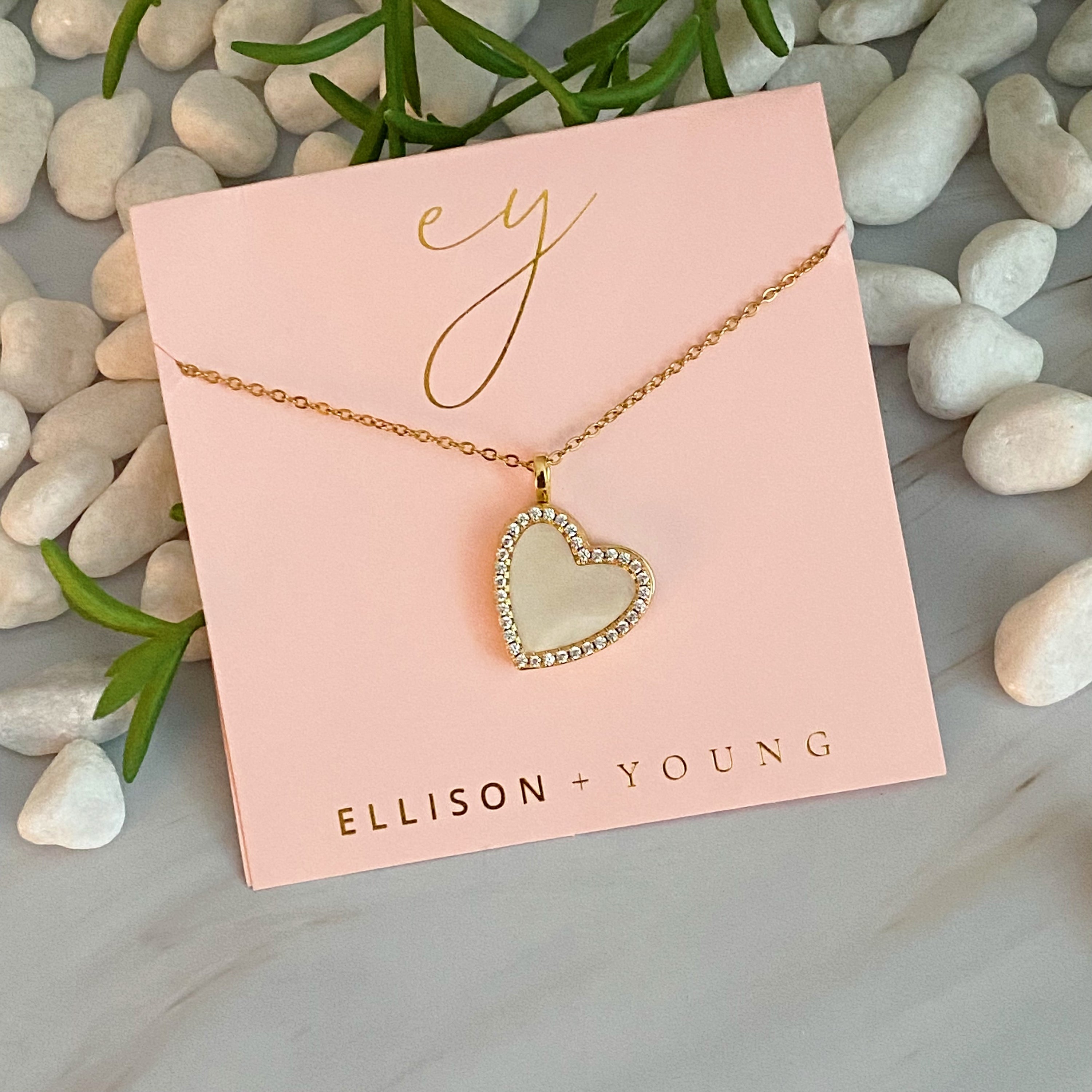 Elegant Shell Heart Locket Pendant Necklace with mother of pearl and gold plating, featuring a delicate design and adjustable chain.