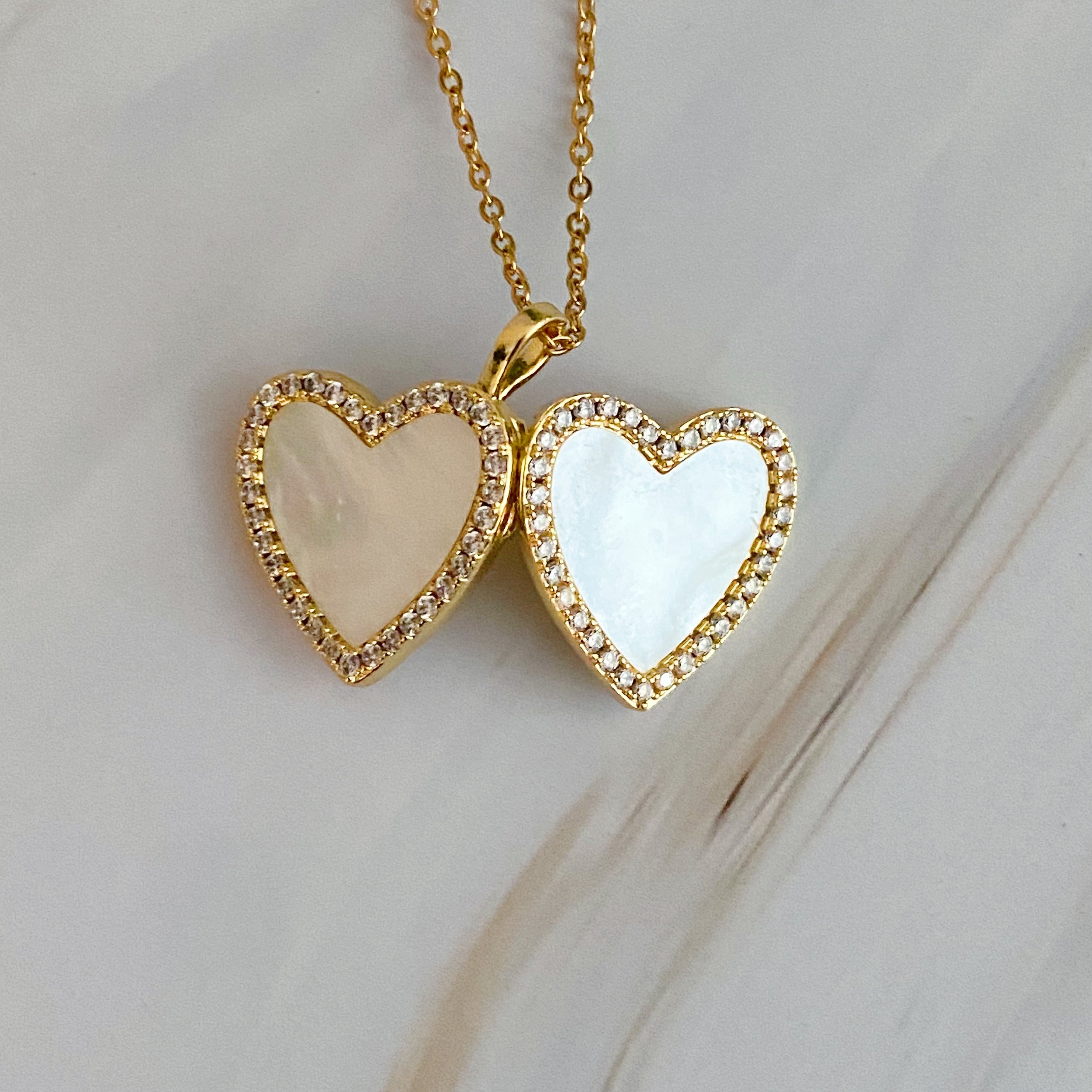 Elegant Shell Heart Locket Pendant Necklace with mother of pearl and gold plating, featuring a delicate design and adjustable chain.