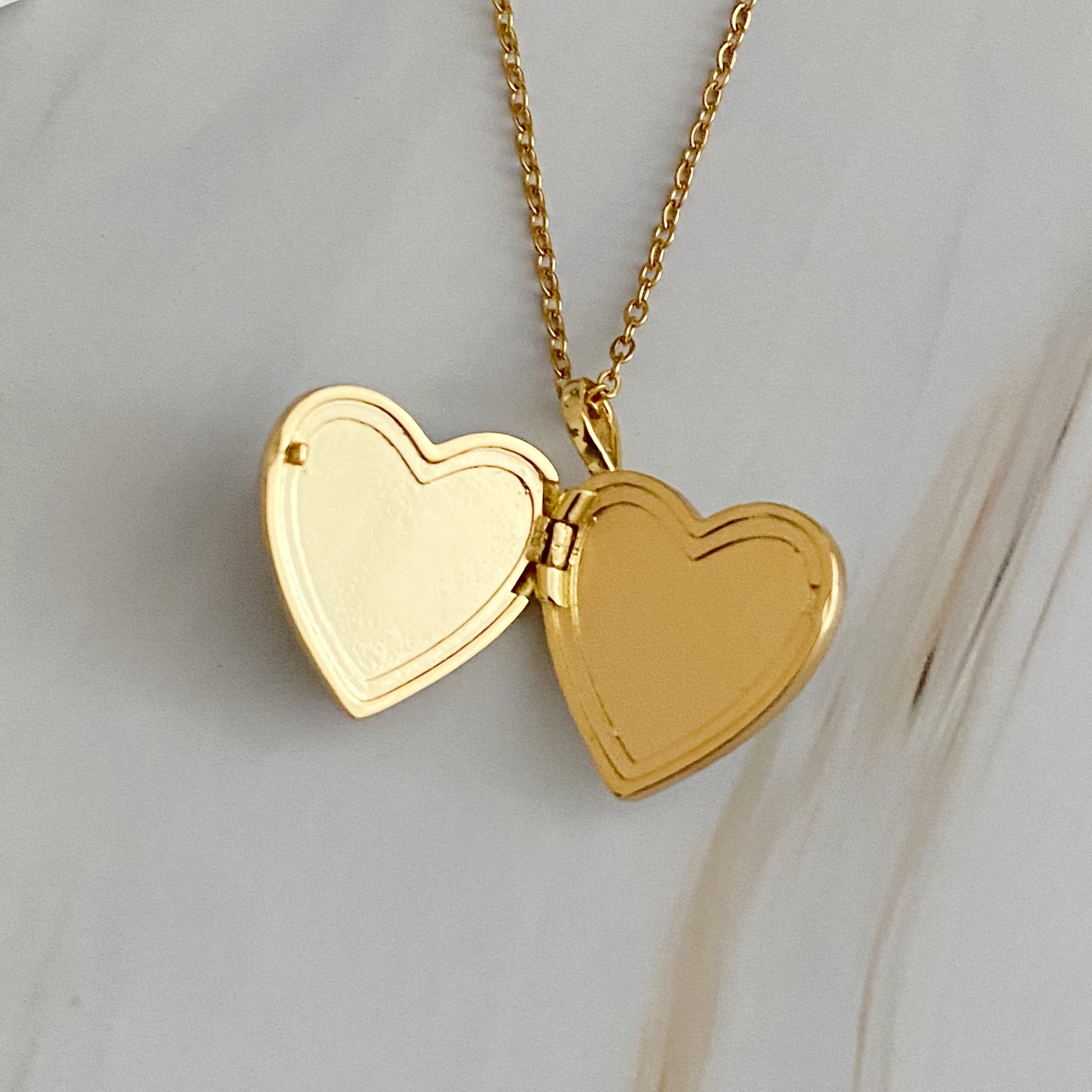 Elegant Shell Heart Locket Pendant Necklace with mother of pearl and gold plating, featuring a delicate design and adjustable chain.