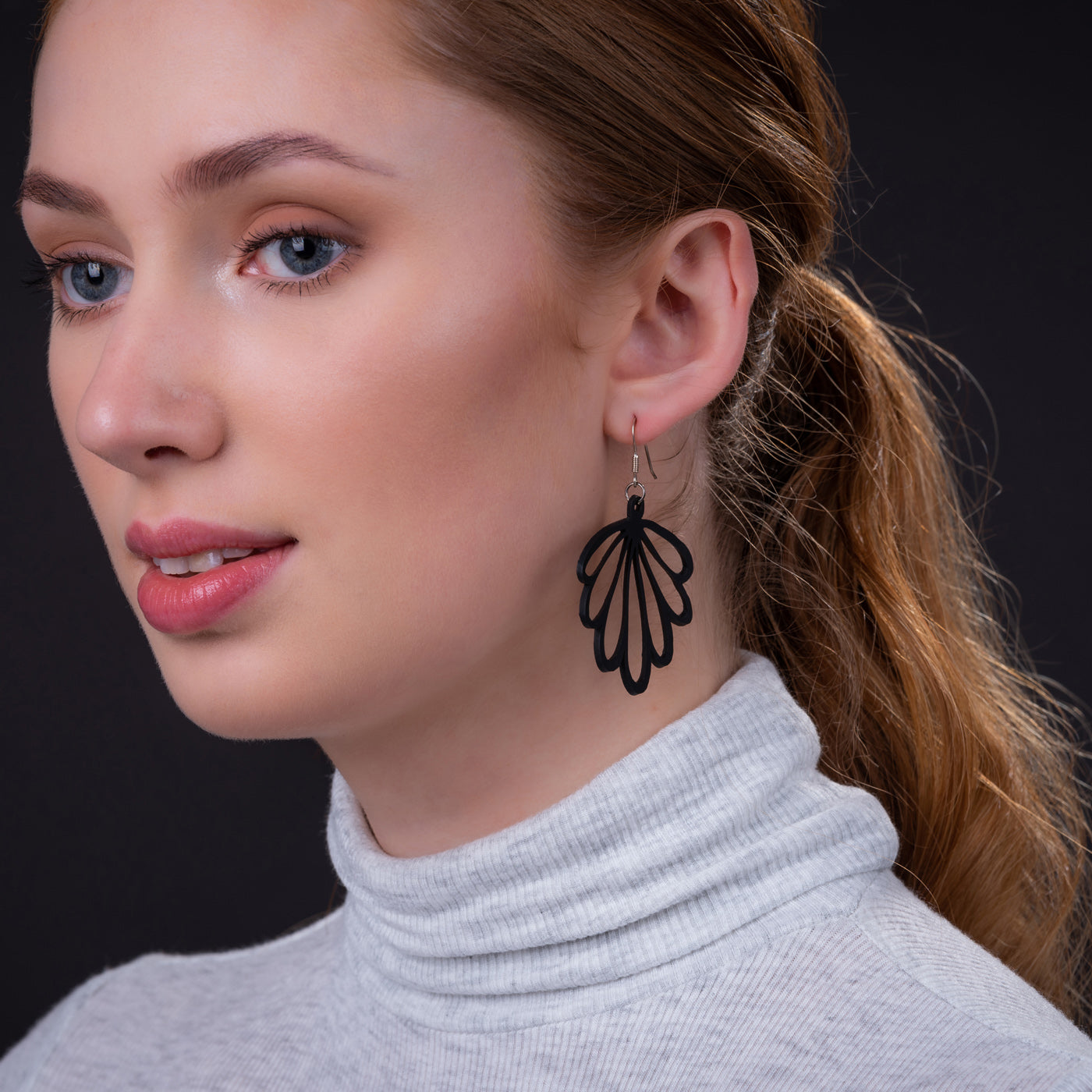 A pair of handmade Shell Recycled Rubber Earrings featuring unique patterns and sterling silver hooks, showcasing eco-friendly fashion.