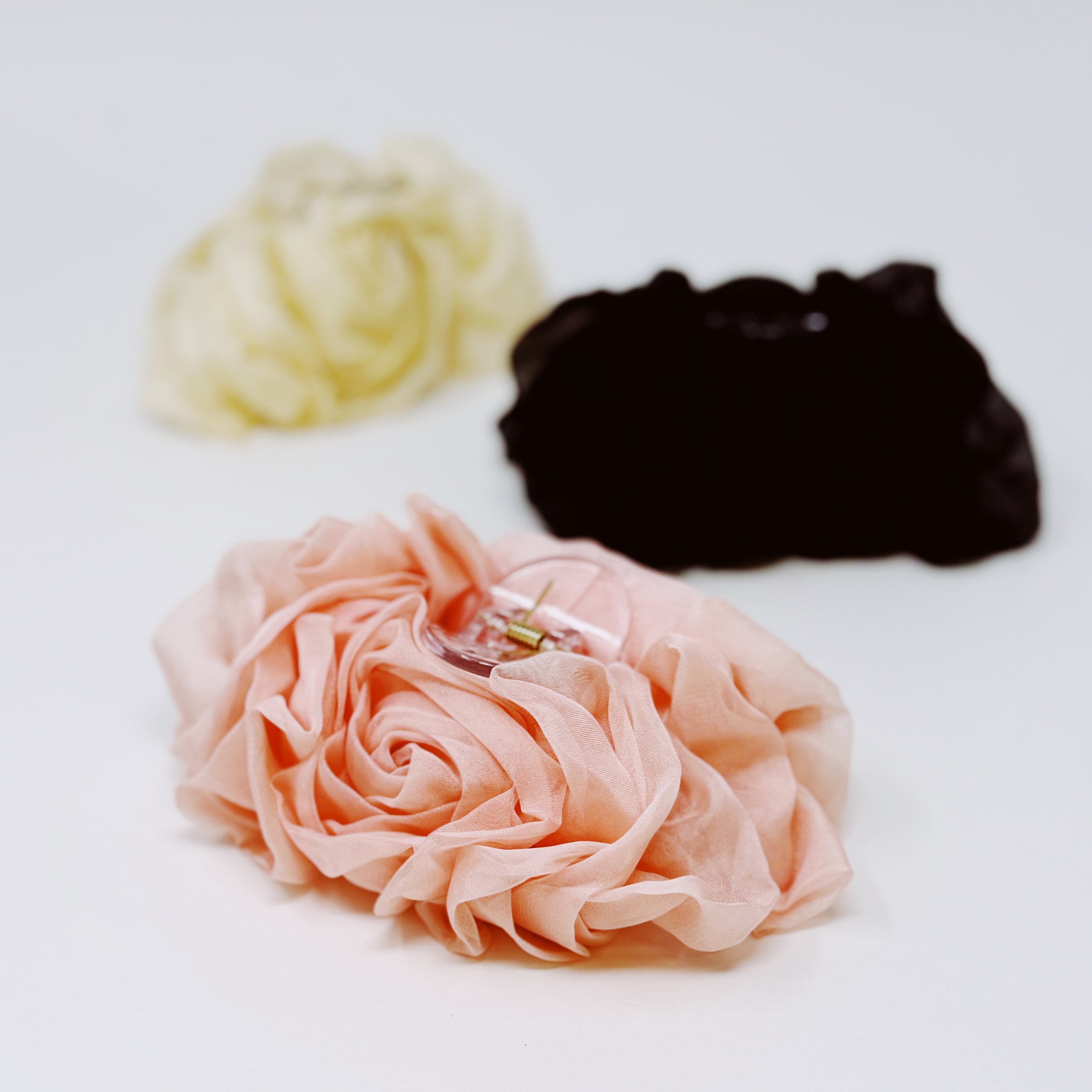 A delicate sheer flower hair claw with a beautiful design, perfect for securing hairstyles elegantly.