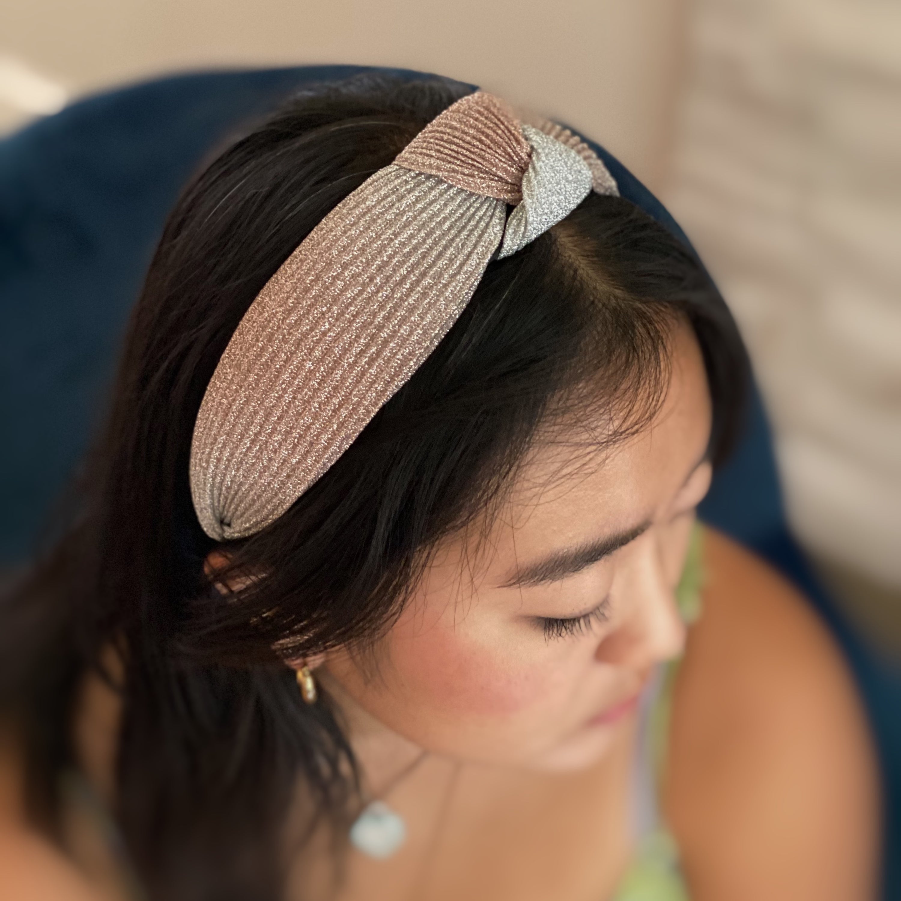 A stylish Shimmer Pleats Headband featuring a shimmering ombre design and pleated texture, perfect for any occasion.