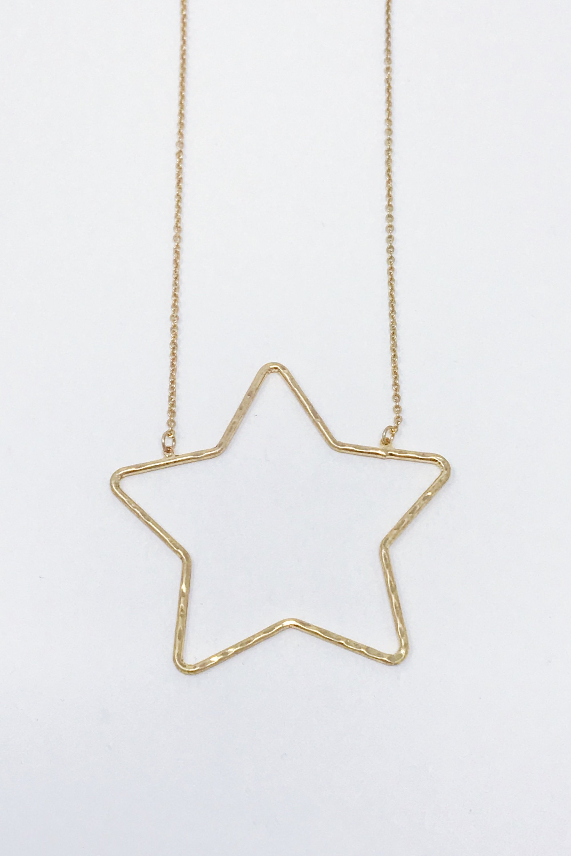 Gold Shine Baby Star Necklace featuring a large hammered finish star pendant, elegantly designed for stylish wear.